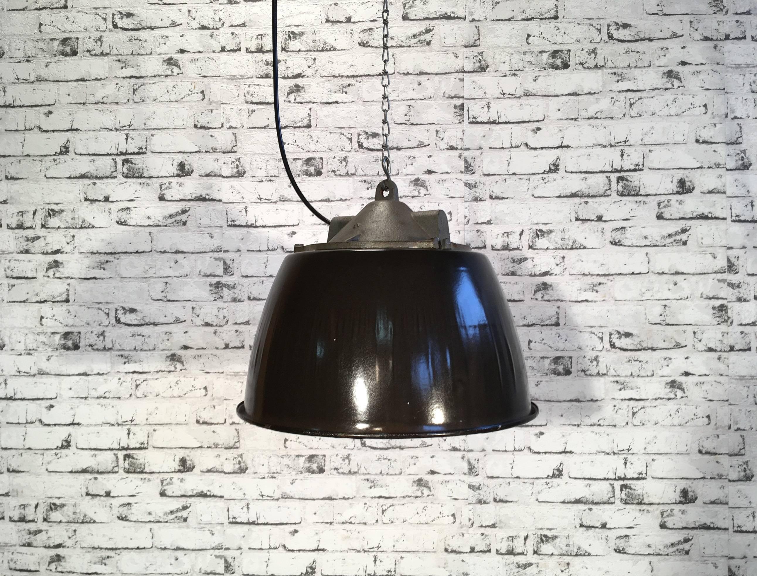 Industrial black enamel lamp with white enamel interior. Cast iron top. Iron grid. Striped glass. Porcelain socket for E27 lightbulbs.  New wire. The weight of the lamp is 6 kg.
