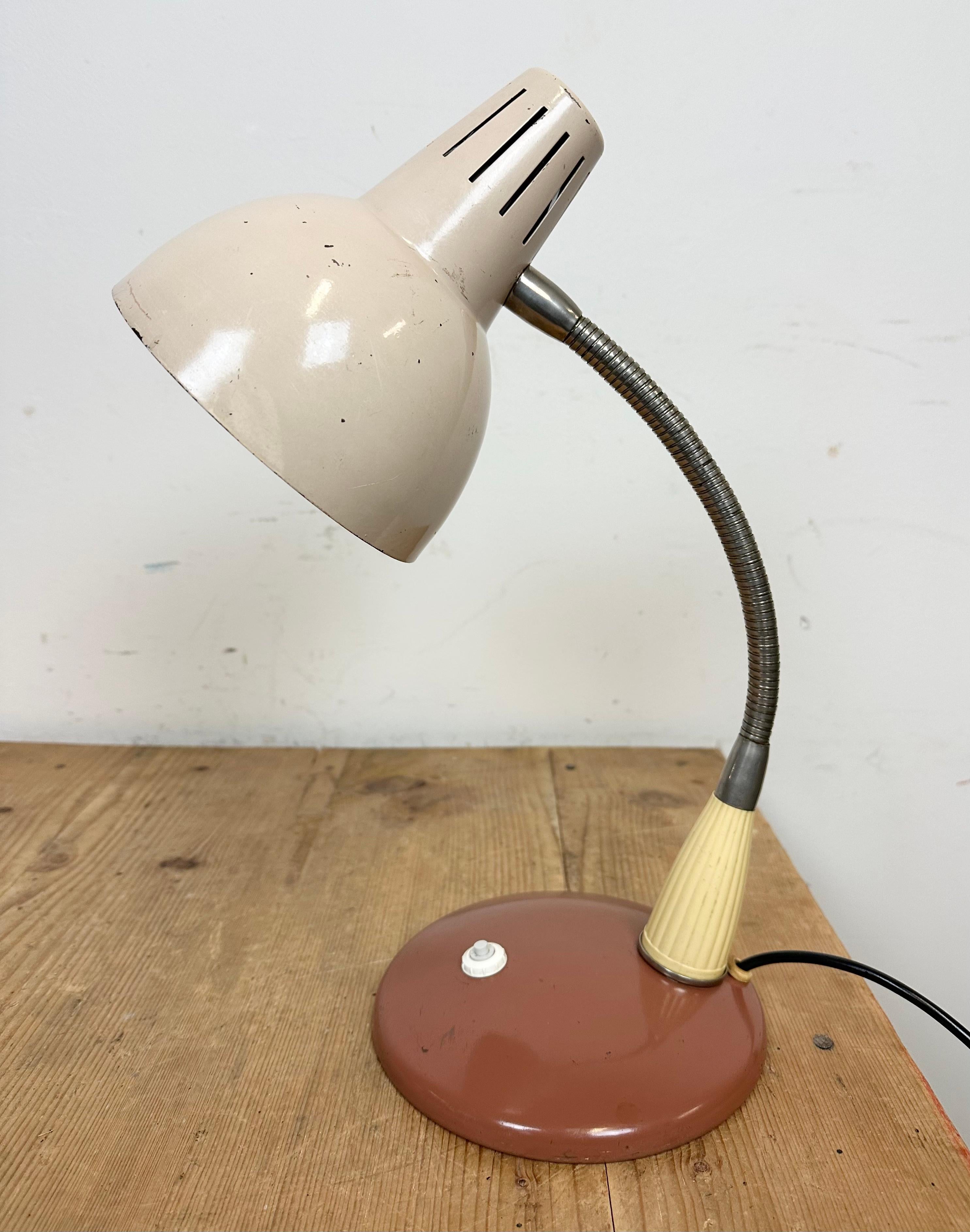 Industrial workshop table lamp made in Poland during the 1960s. It features a metal base and shade and a chrome plated gooseneck. The porcelain socket requires E27/E26 lightbulbs.
The diameter of the shade is 15 cm. fully functional.