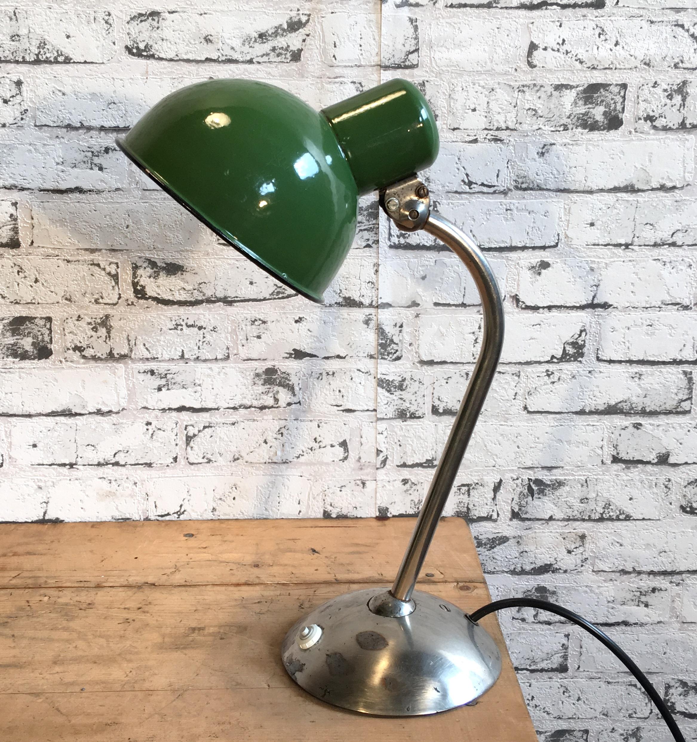 Green industrial table lamp was made during the 1930s. It features a green enamel shade, white enamel interior and a iron chrome plated base with two adjustable joints. New porcelain socket for E 27 lghtbulbs and wire. Fully functional. Measures: