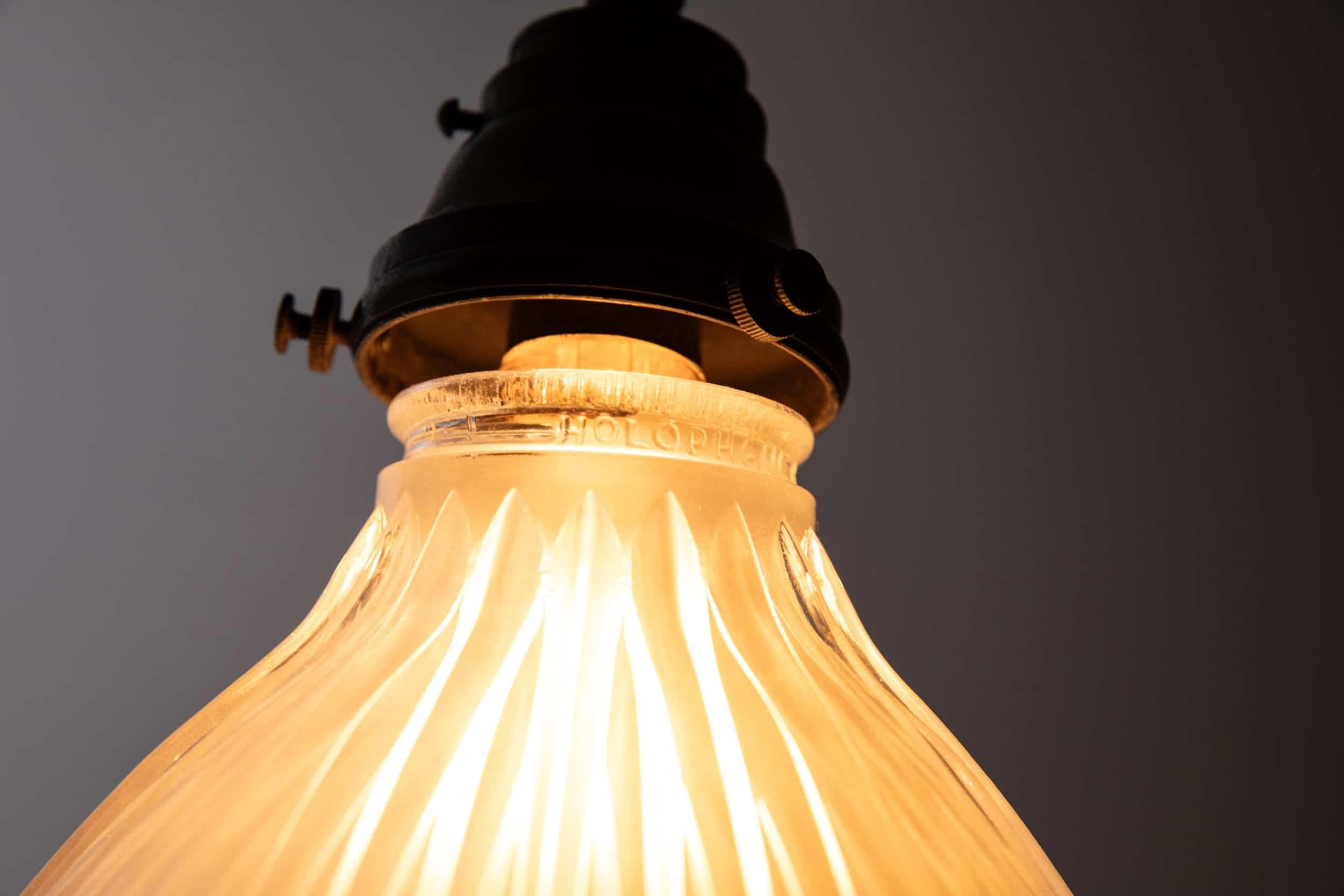 Elegantly formed glass pendant light made in England by Holophane. c.1920

Prismatic glass shade with Holophane stamp to the rim of the shade and original cast brass gallery.

Rewired with 1m of black twist flex.

About the maker
Holophane was