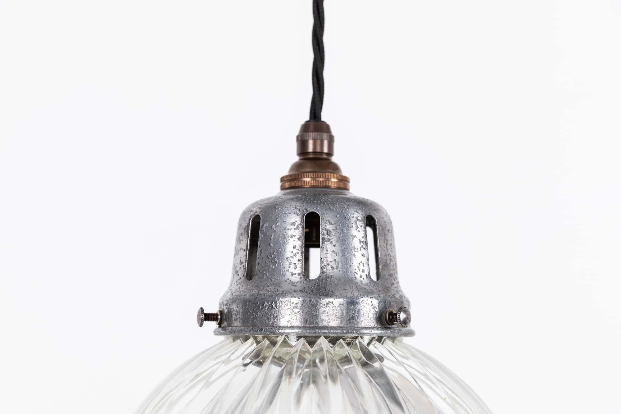 Elegantly formed glass pendant light made in England by Holophane. c.1920

Prismatic glass shade with Holophane stamp to the rim of the shade and alloy gallery.

Rewired with 1m of black twist flex.

About the maker
Holophane was founded in 1896 by