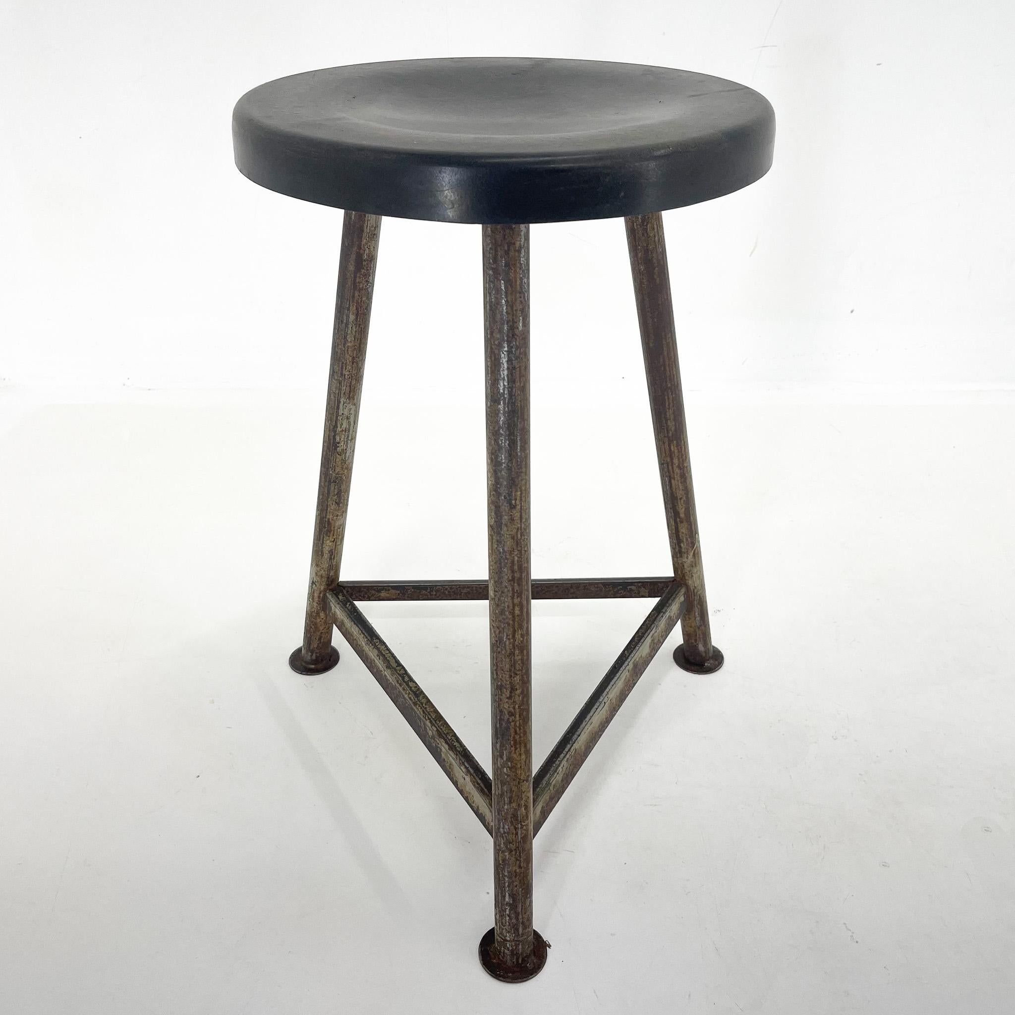 Vintage industrial tripod stool, made of iron and plastic. Saved from a factory in former Czechoslovakia. Thouroughly cleaned. The diameter of the seat is 37 cm. The widest point at the bottom of the legs is 47 cm.