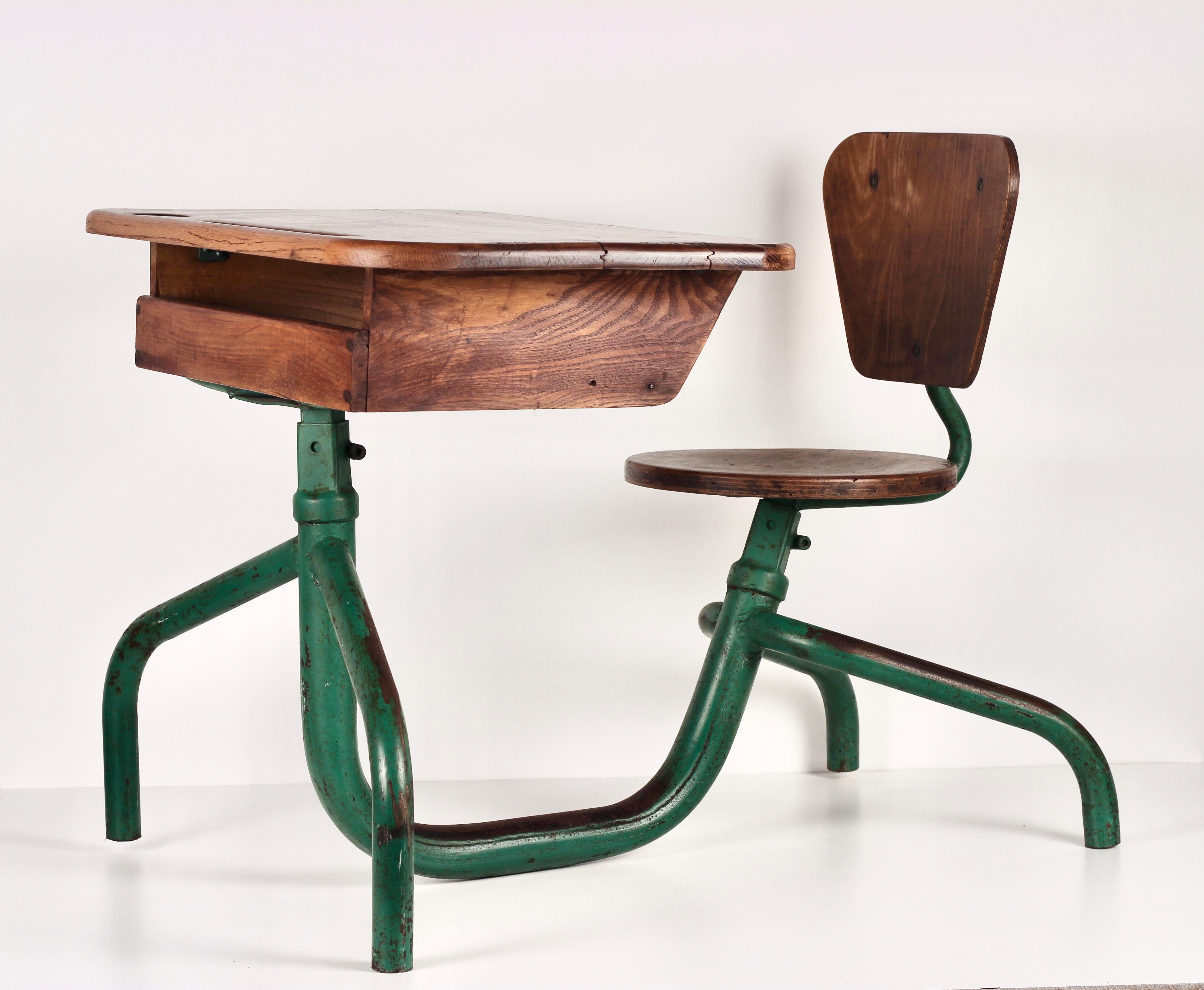 An original 1950’s French School desk, made from Oak, Ply and Steel in the style of Jean Prouvé. 
Green lacquered metal base with original solid oak top and seat.
In very good condition, showing age related wear which creates a beautiful patina and