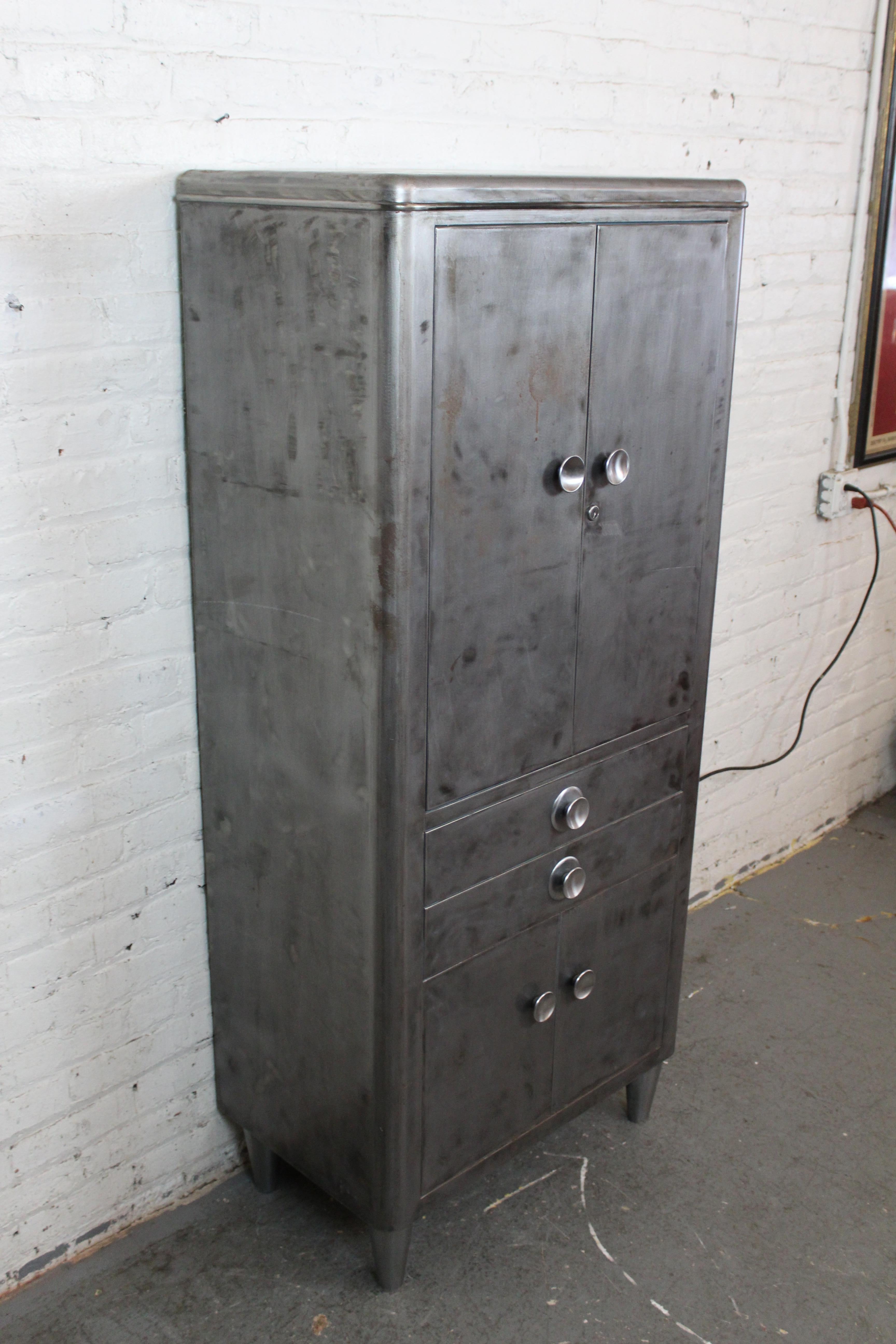 Relive the splendor and glory of America's Industrial Age with this fantastic and practical vintage medical cabinet by the esteemed builders of Hamilton Manufacturing Co. of Two Rivers, Wisconsin. This spacious cabinet, originally sold by South