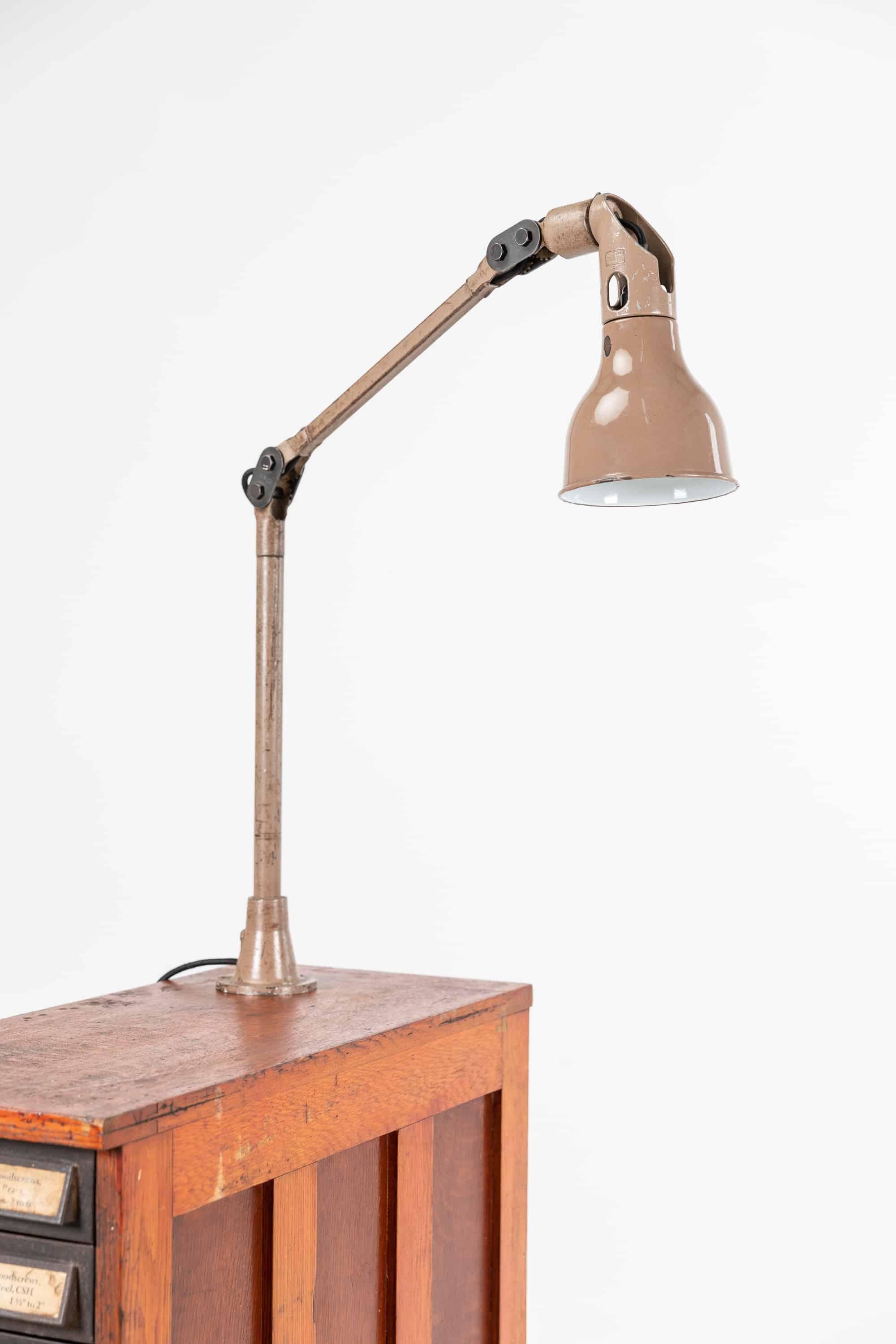 Highly original post-war design of the classic machinist's work lamp by Mek Elek, London. c.1950

Originally designed for use in machine shops, usually mounted to lathes and milling machines. In the original factory applied taupe paint. EIIR