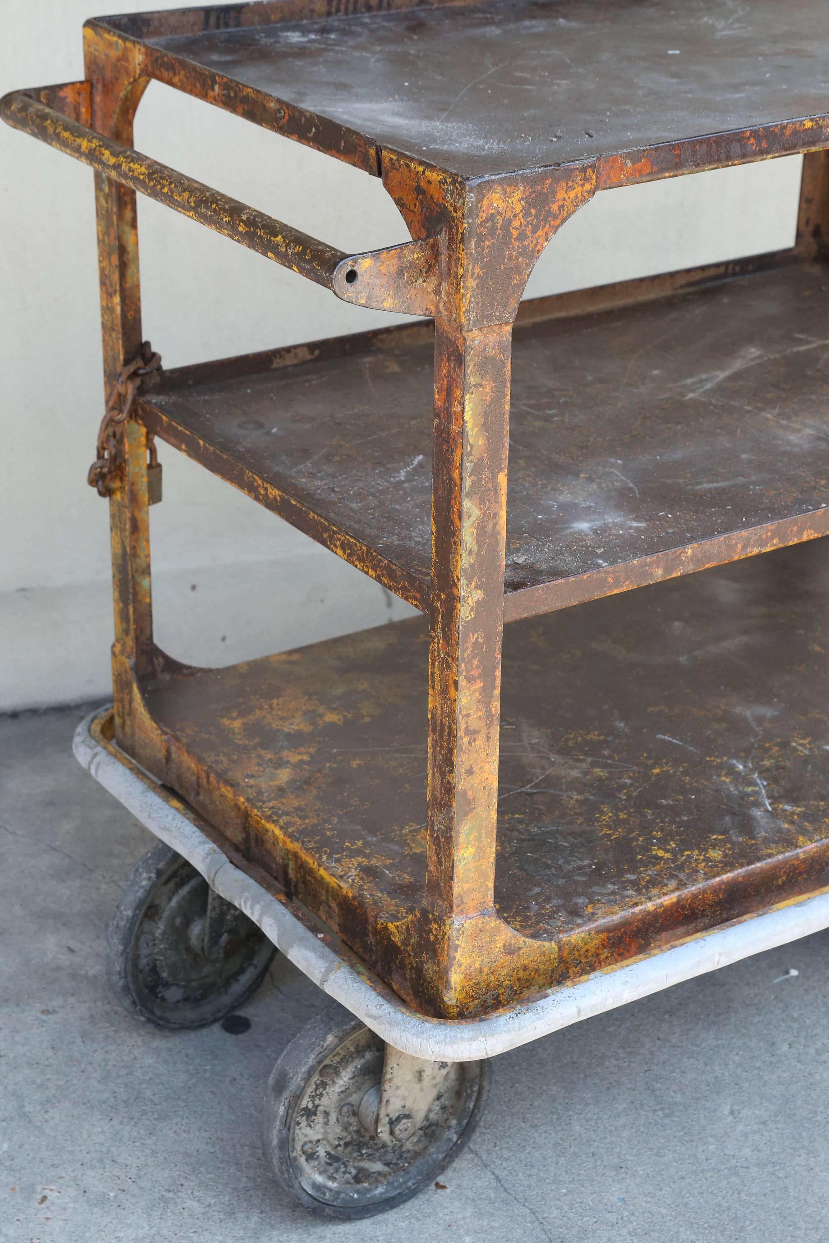 We love an industrial cart for use as a bar cart, and this fantastic cart has all of our favorite things, a distressed finish, large wheels that allow for smooth movement and plenty of space for bottles, glasses, trays and ice buckets! This metal