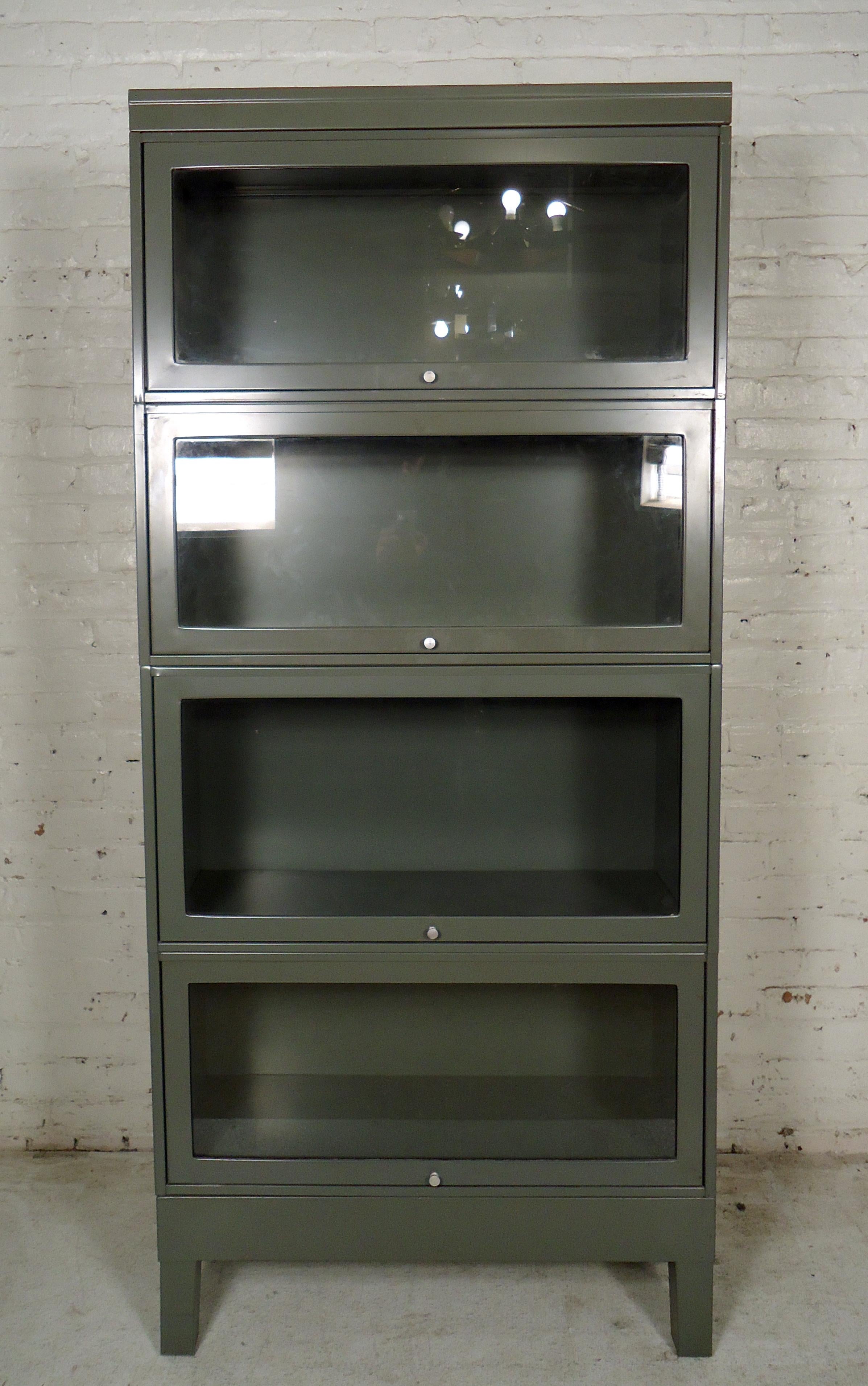 Vintage stackable barrister bookcase painted in a gray finish features four spacious storage barristers stacked on top of each other.

 