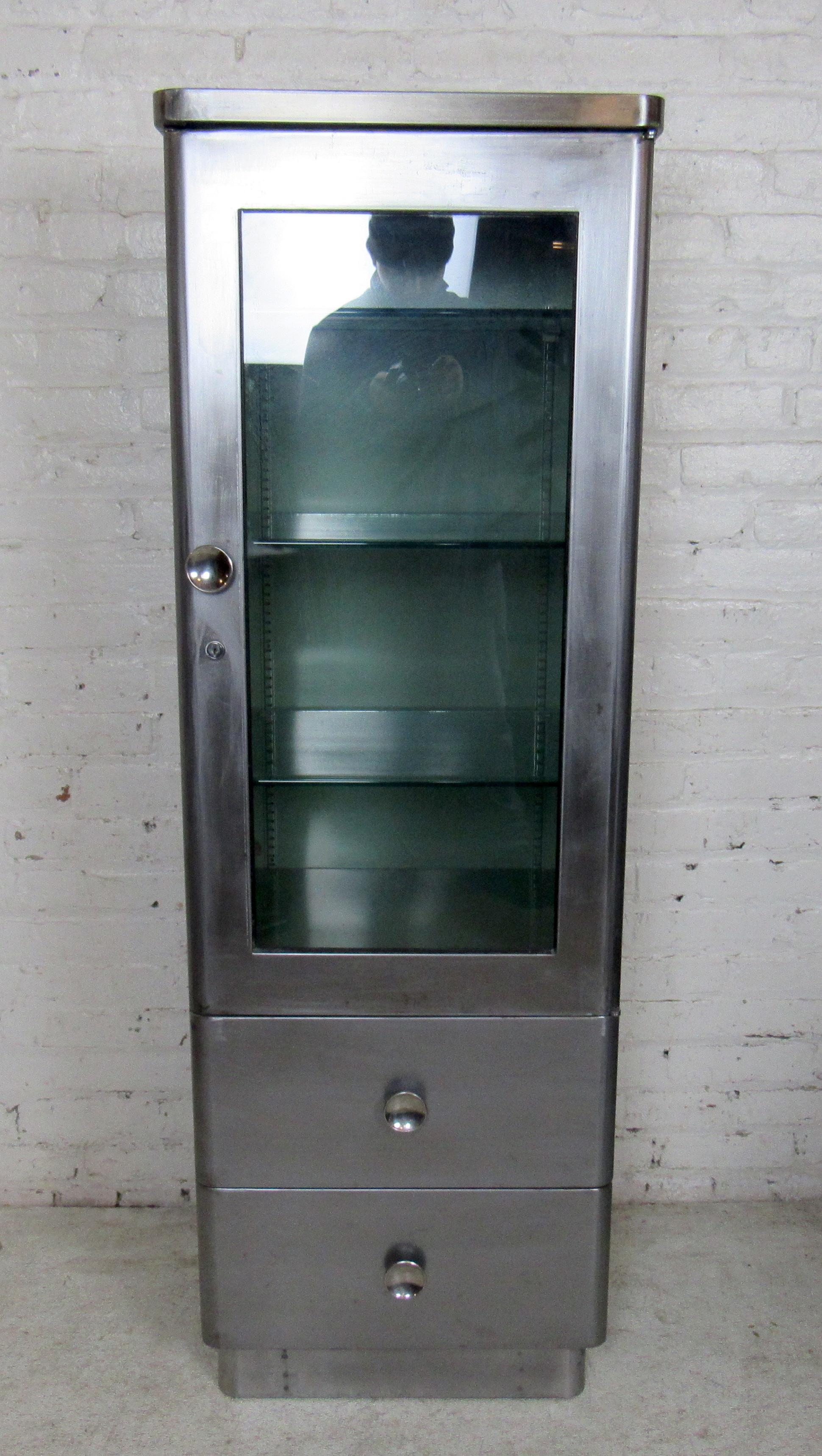 Vintage medical cabinet stripped to bare metal and lacquered for a handsome industrial look. Two lower drawers, top cabinet featuring many glass shelves.

Please confirm item location - NY or NJ - with dealer.
  