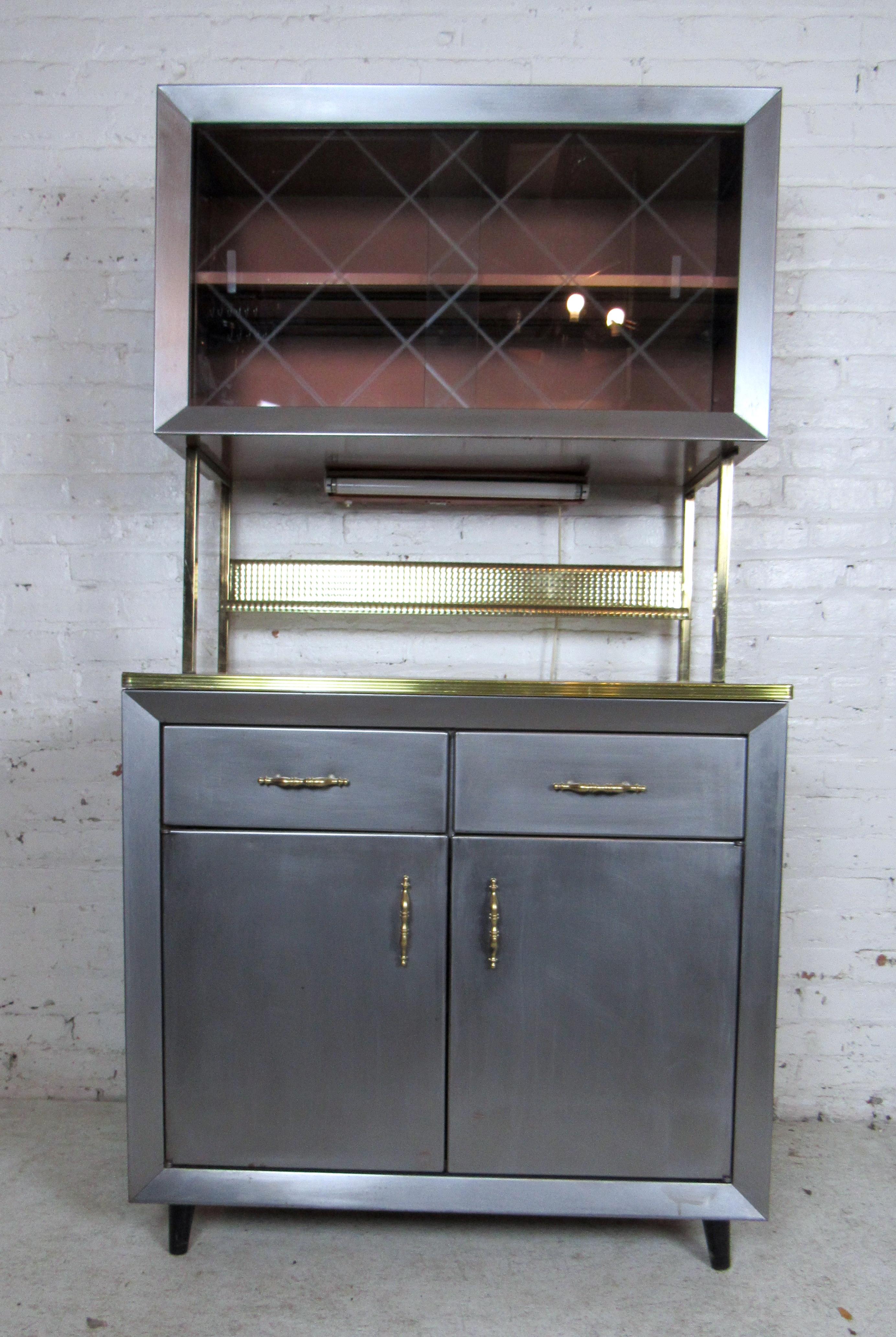 Sleek vintage metal cabinet featuring two drawers, a spacious storage cabinet below.
The top hutch includes glass sliding doors and one shelf.

Please confirm item location with dealer (NJ or NY).