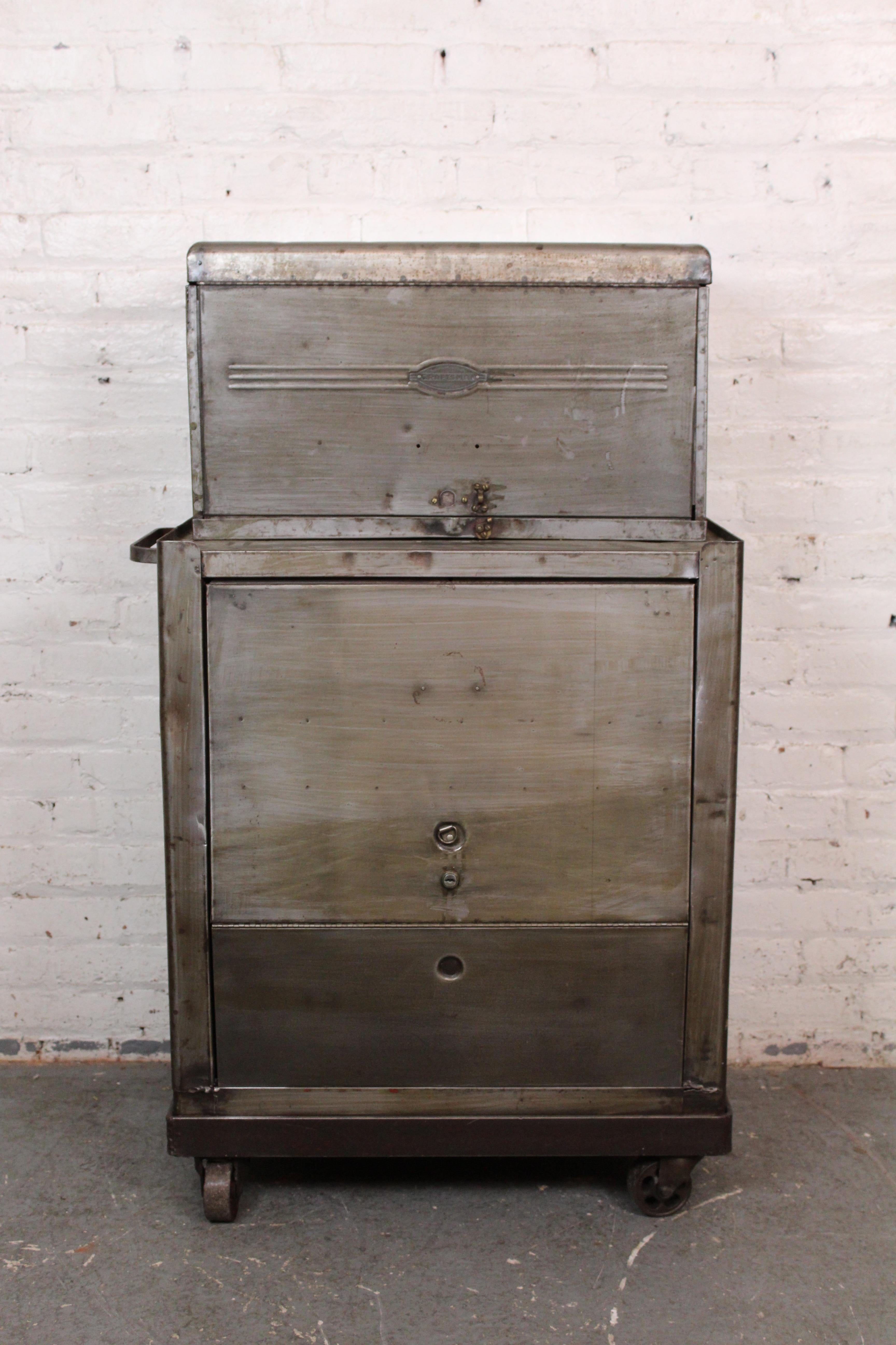 Bring home genuine industrial metal and inject any space with classic everyman  style! This rare rolling tool chest made by Craftsman exclusively for Sears Roebuck has a unique half-stack appearance with a rising steel door that tucks away to reveal