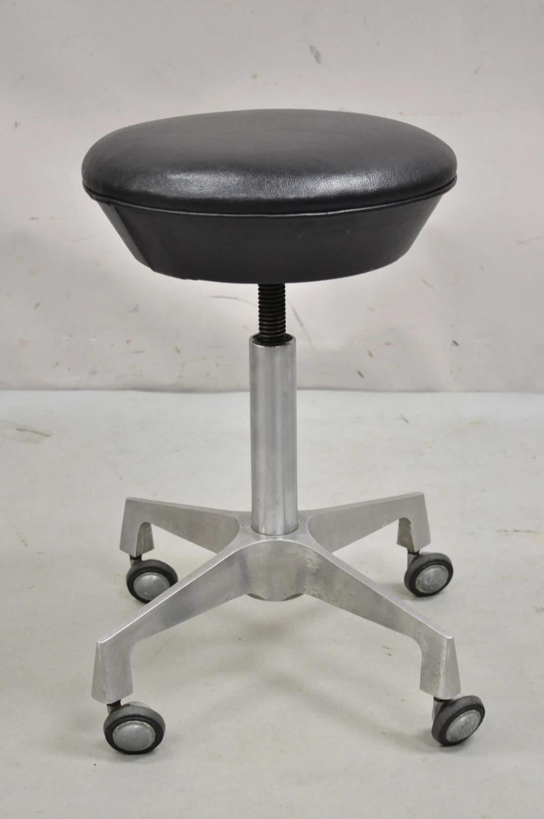 Vintage Industrial Modern Cast Aluminum Adjustable Rolling Medical Dental Stool. Circa Mid 20th Century. Measurements: 18-24