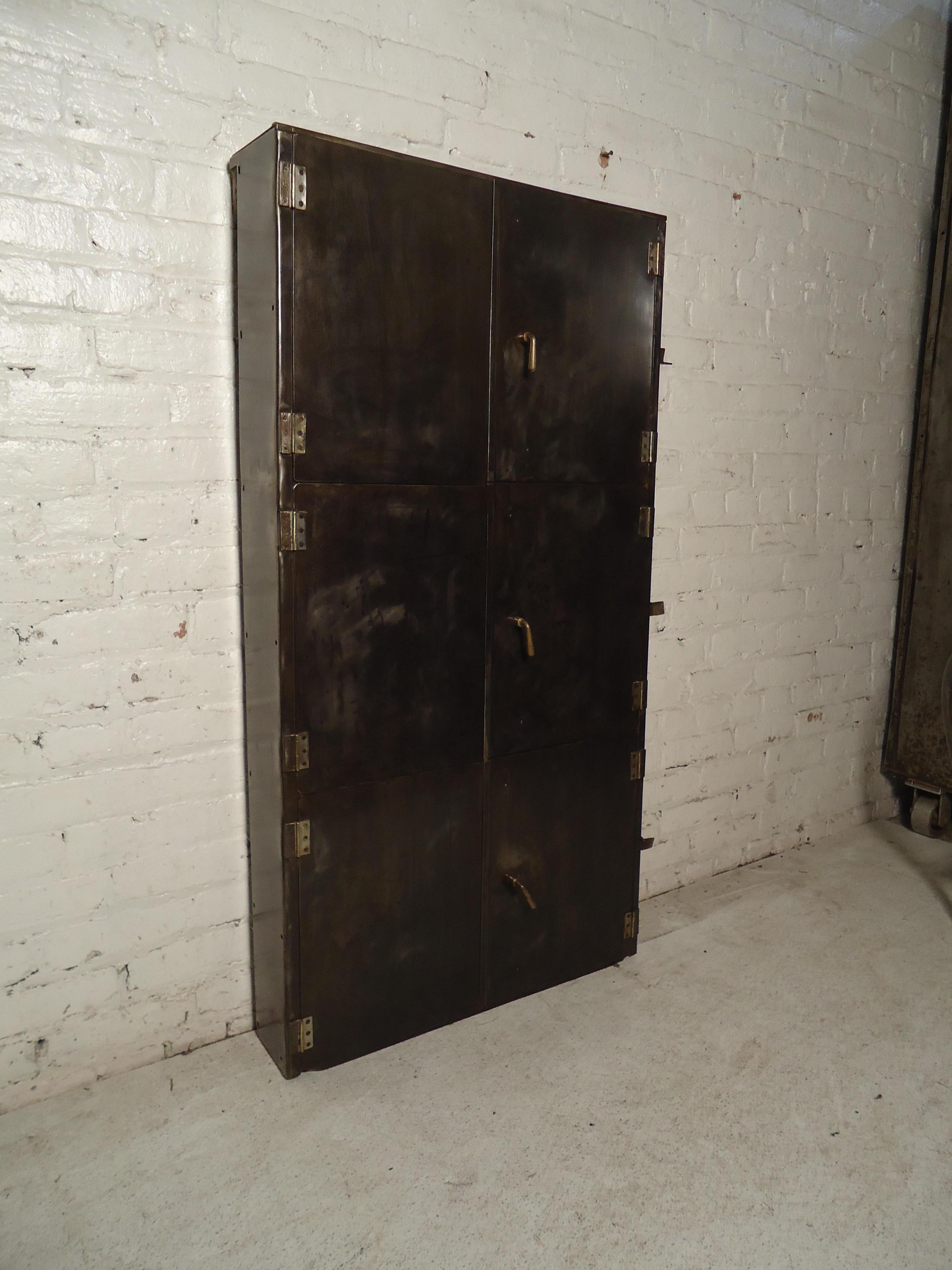Vintage modern industrial metal wall-mounted cabinet features three shelves, and metal knobs.
(Please confirm item location - NY or NJ - with dealer).