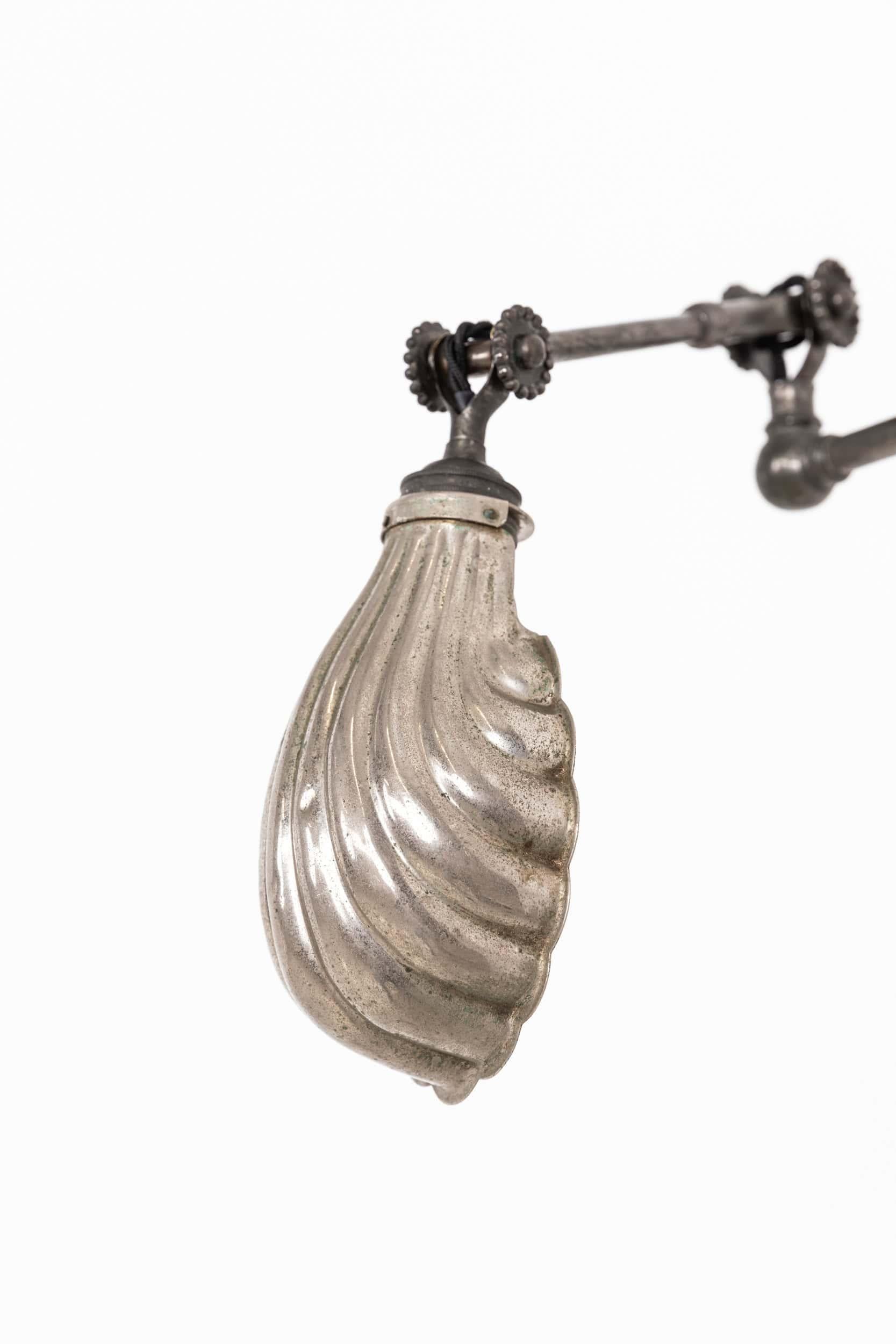 

Beautifully engineered workman's lamp designed by renowned lighting manufacturer Dugdills. c.1920

Smaller than usual scale, in as found condition retaining the original nickel-plated finish. Ornate wall plate embossed with makers name and aged