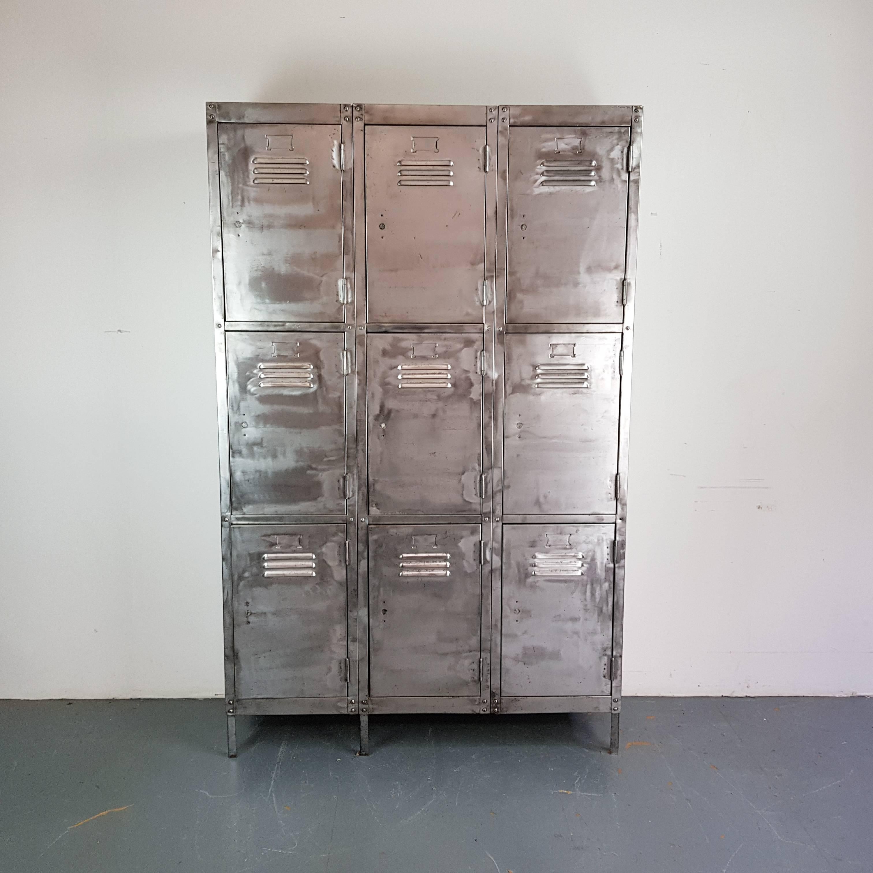 Vintage hand stripped and polished steel school locker with nine compartments.

The insides retain the original painted finish. 

Please note that, due to its age and the type of setting it's been salvaged from, there are signs of wear including