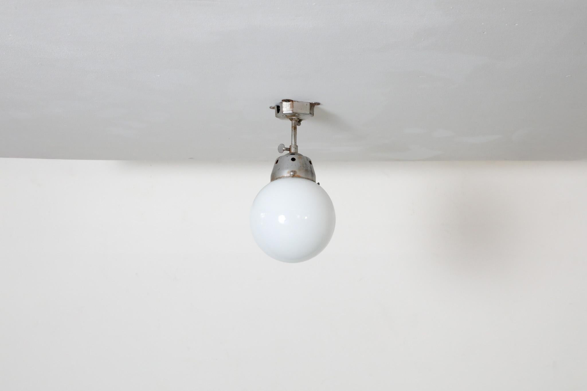 Vintage Industrial Opaline Glass Globe Light with Raw Metal Mounting For Sale 4