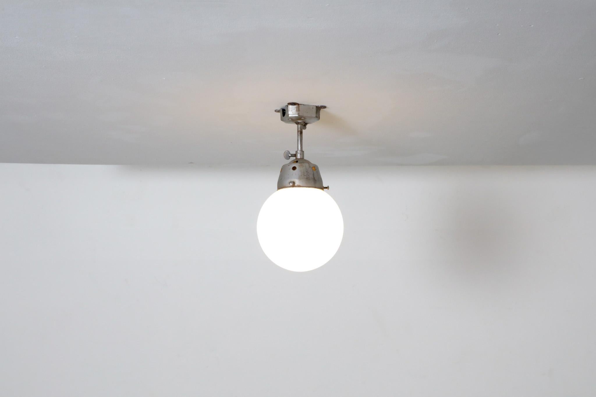 Mid-Century Modern Vintage Industrial Opaline Glass Globe Light with Raw Metal Mounting For Sale
