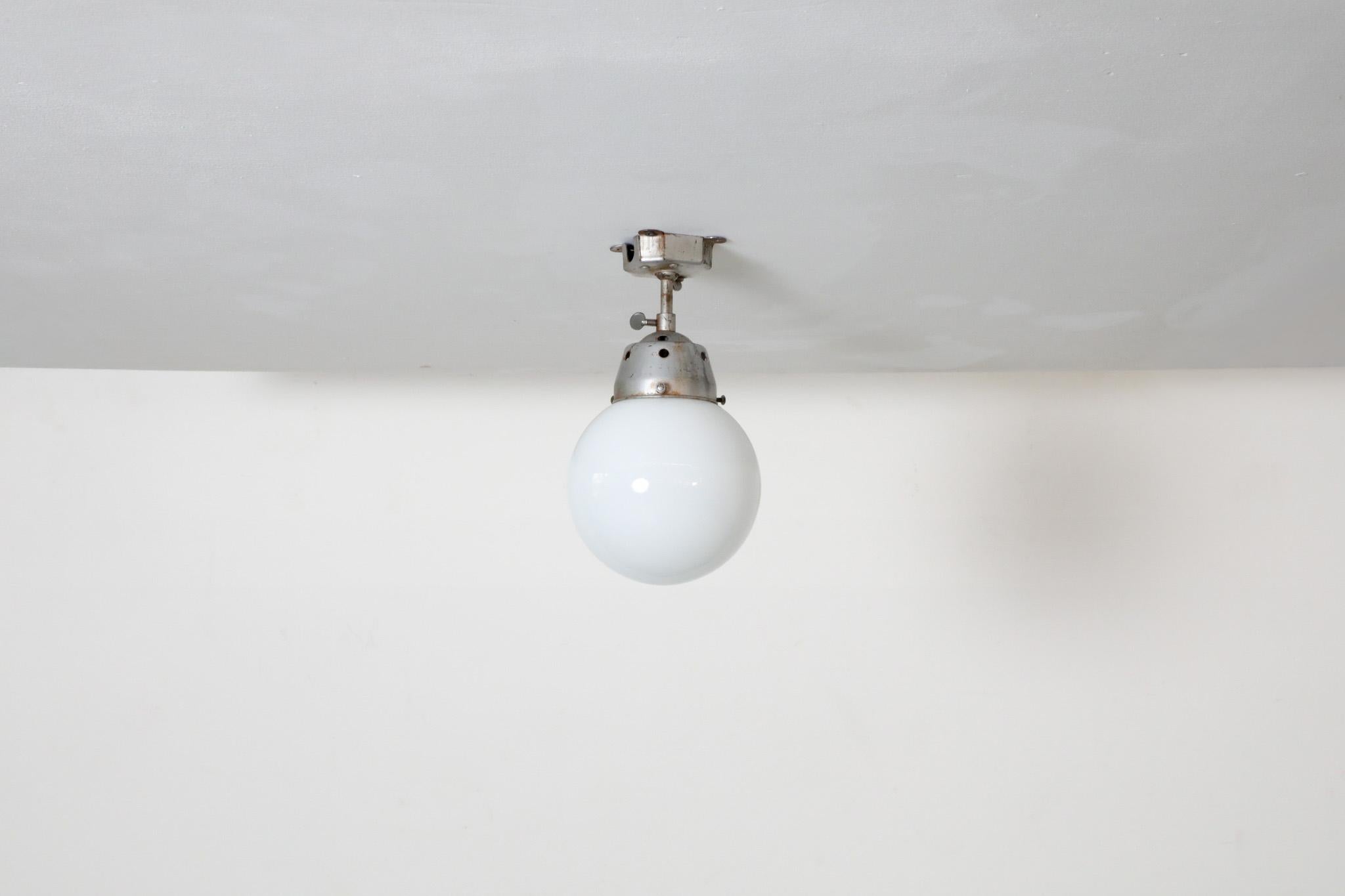 20th Century Vintage Industrial Opaline Glass Globe Light with Raw Metal Mounting For Sale