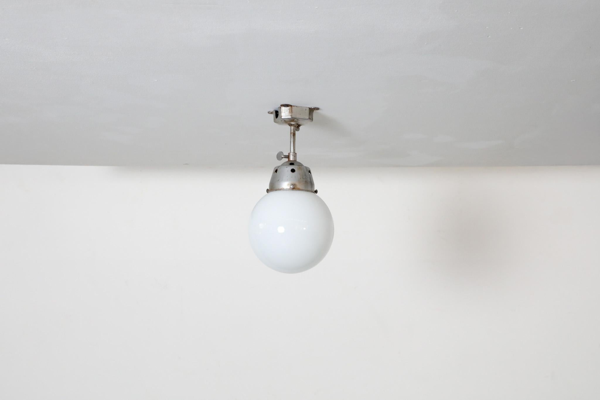 Vintage Industrial Opaline Glass Globe Light with Raw Metal Mounting For Sale 1