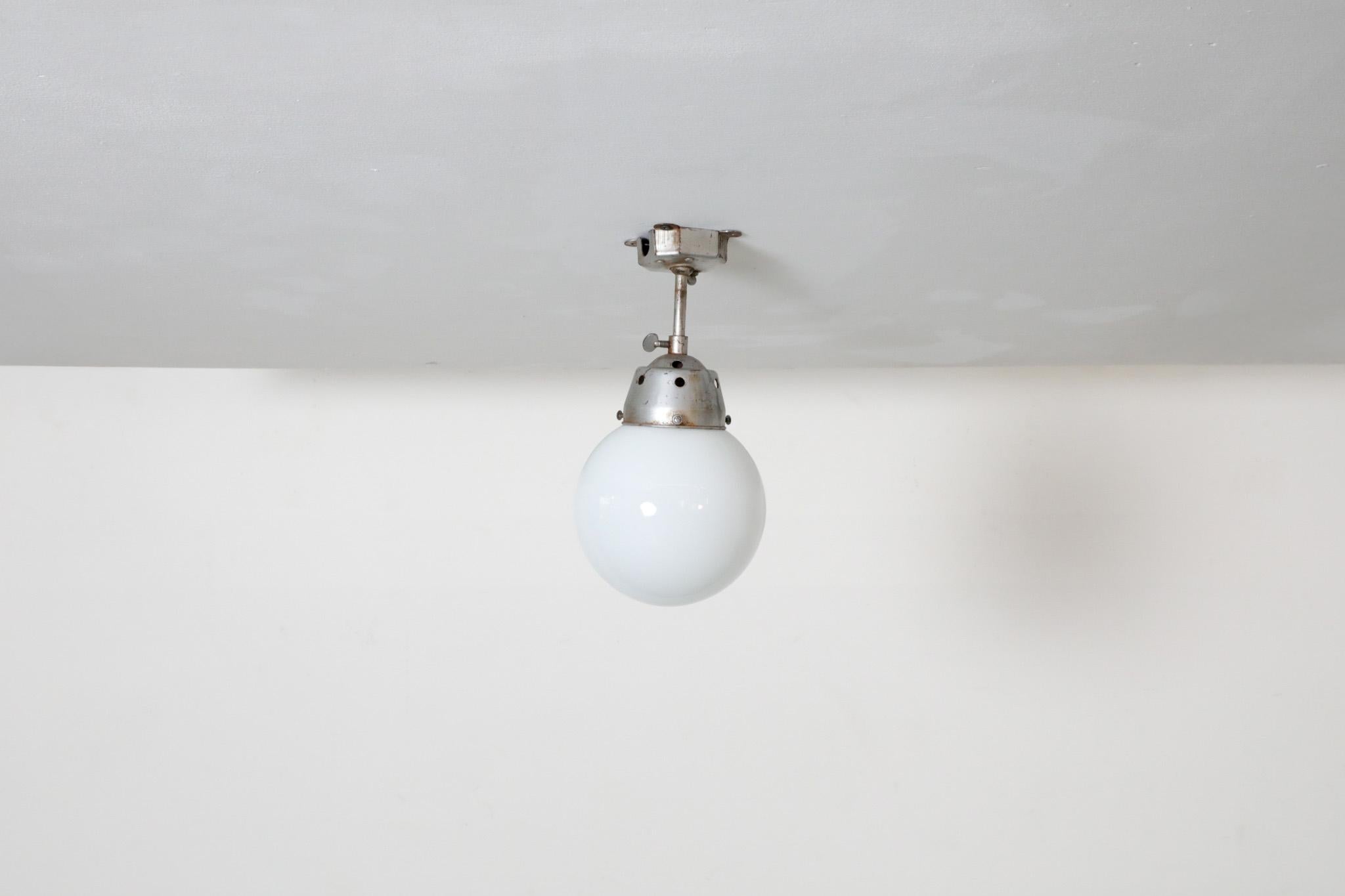 Vintage Industrial Opaline Glass Globe Light with Raw Metal Mounting For Sale 3