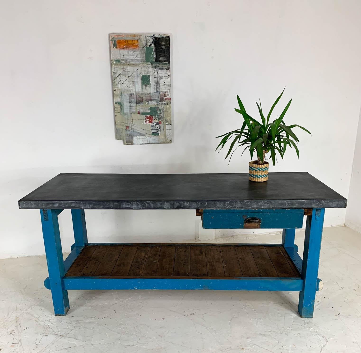 Mid-20th century workbench sourced from a carpenter's workshop in Lincoln. We have added a beautifully aged zinc top which makes an ideal kitchen surface due to it's antibacterial properties. The original blue paint has worn through in places, as