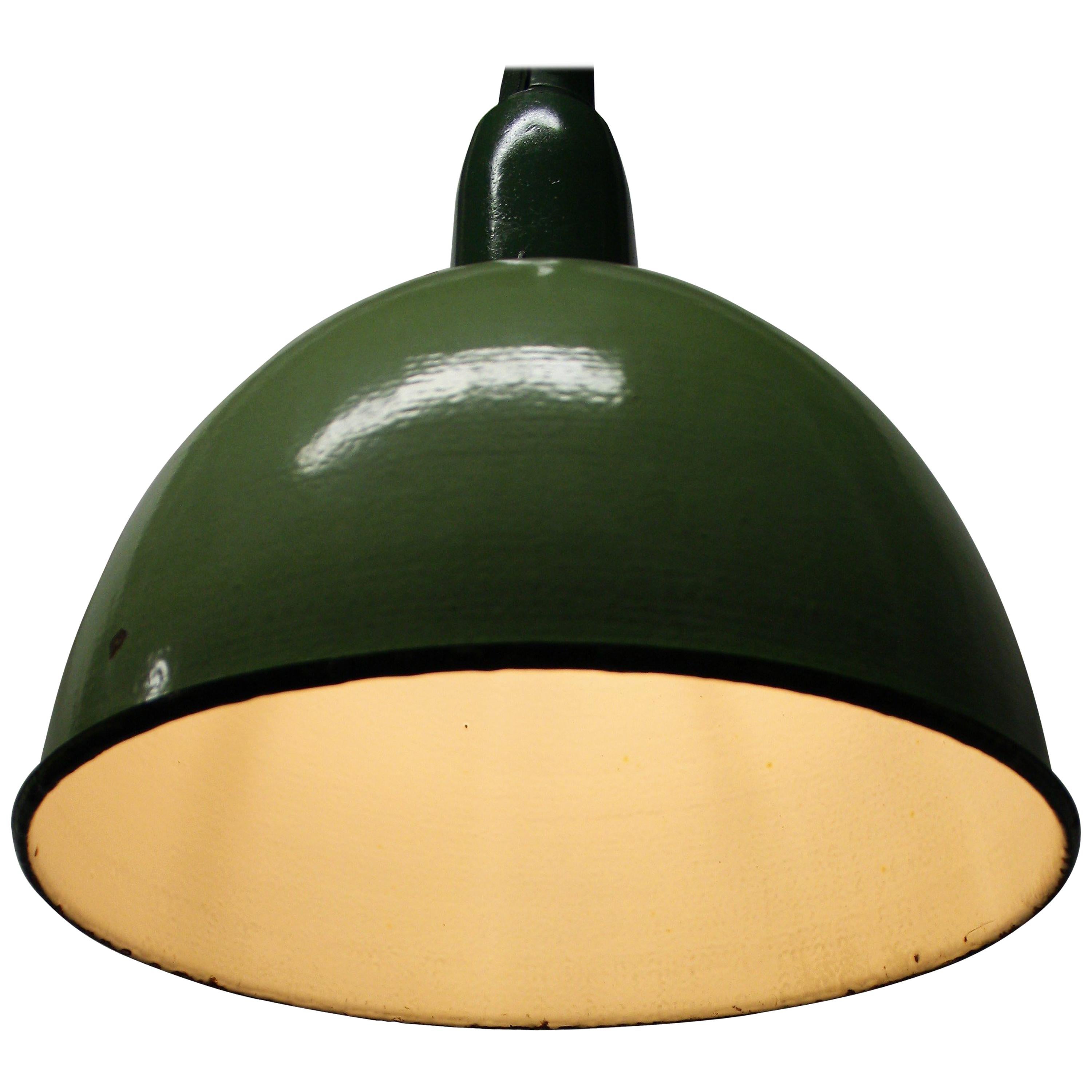 Vintage green enamel pendant lights produced and used in Russia.

These mint green examples are in very good condition.

The lights have cast iron shade holders labeled with 'cccp', former soviet union.

This type of lamps looks great in