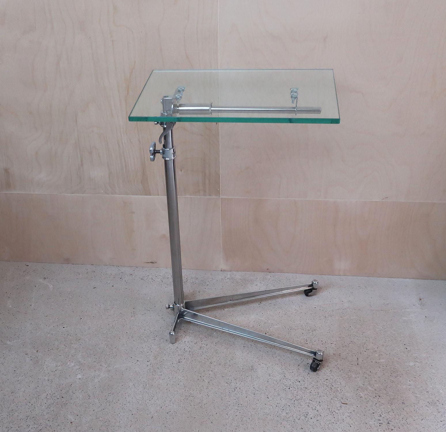 Stylish side or work table with an elegant Industrial look.

Made of polished steel and aluminium with a new toughened glass top.

The top is adjustable by loosening the handle on the side.

The top can also be tilted.

On the original
