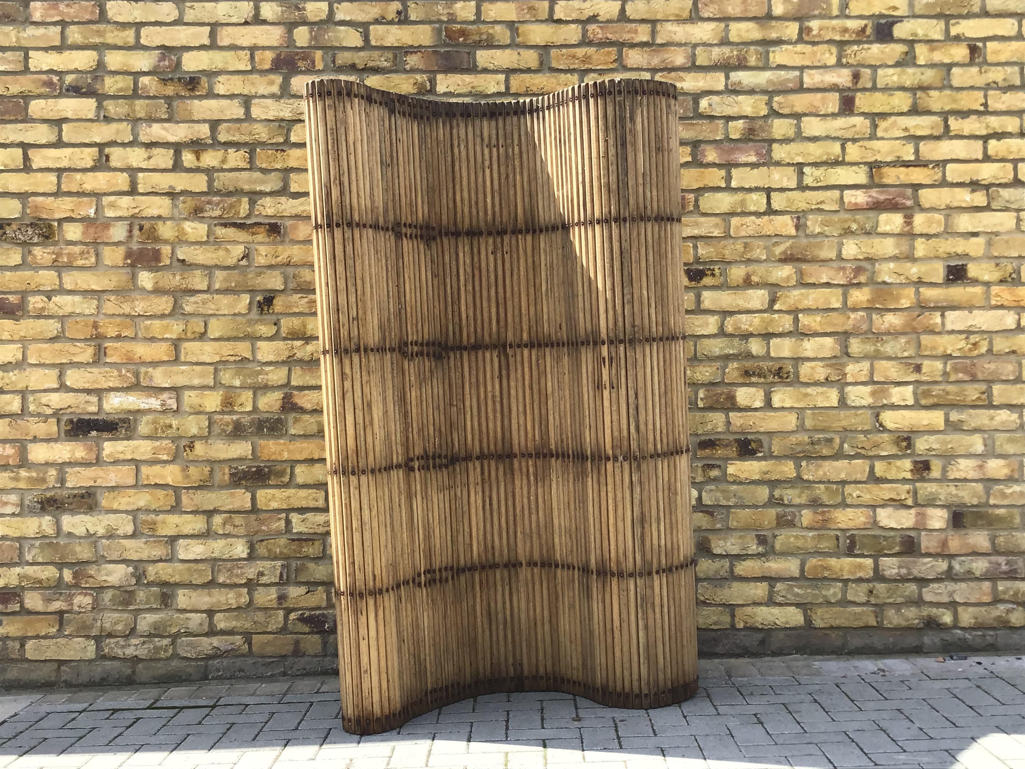 Wonderful vintage Industrial wooden screen. With flexible movement to take on shapes can be rolled up into a cylinder. Fantastic patina on the wood. Originally
From a fabric mill, circa 1930s UK.
  