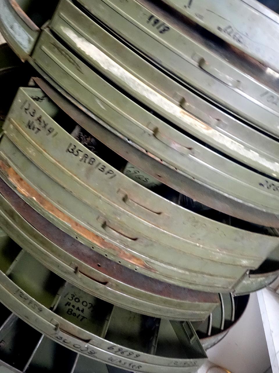 This is one of the more interesting Industrial parts cabinets that you will find. It has eight rotating levels with many removable dividers. What makes this special are the rare draw sections that were used for small parts. It really changes this