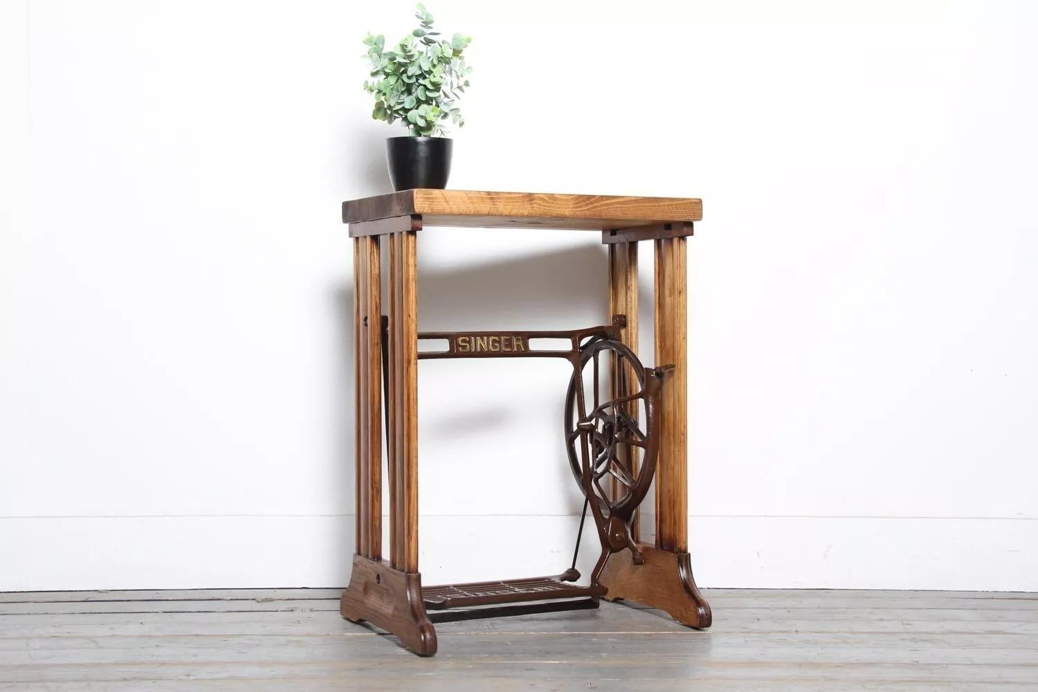 Vintage Industrial Side Table

This striking side table features a reclaimed wooden top that has been waxed and polished for a high-end finish. The top is set on an original 1930s wooden frame with an original Singer treadle and flywheel, making it