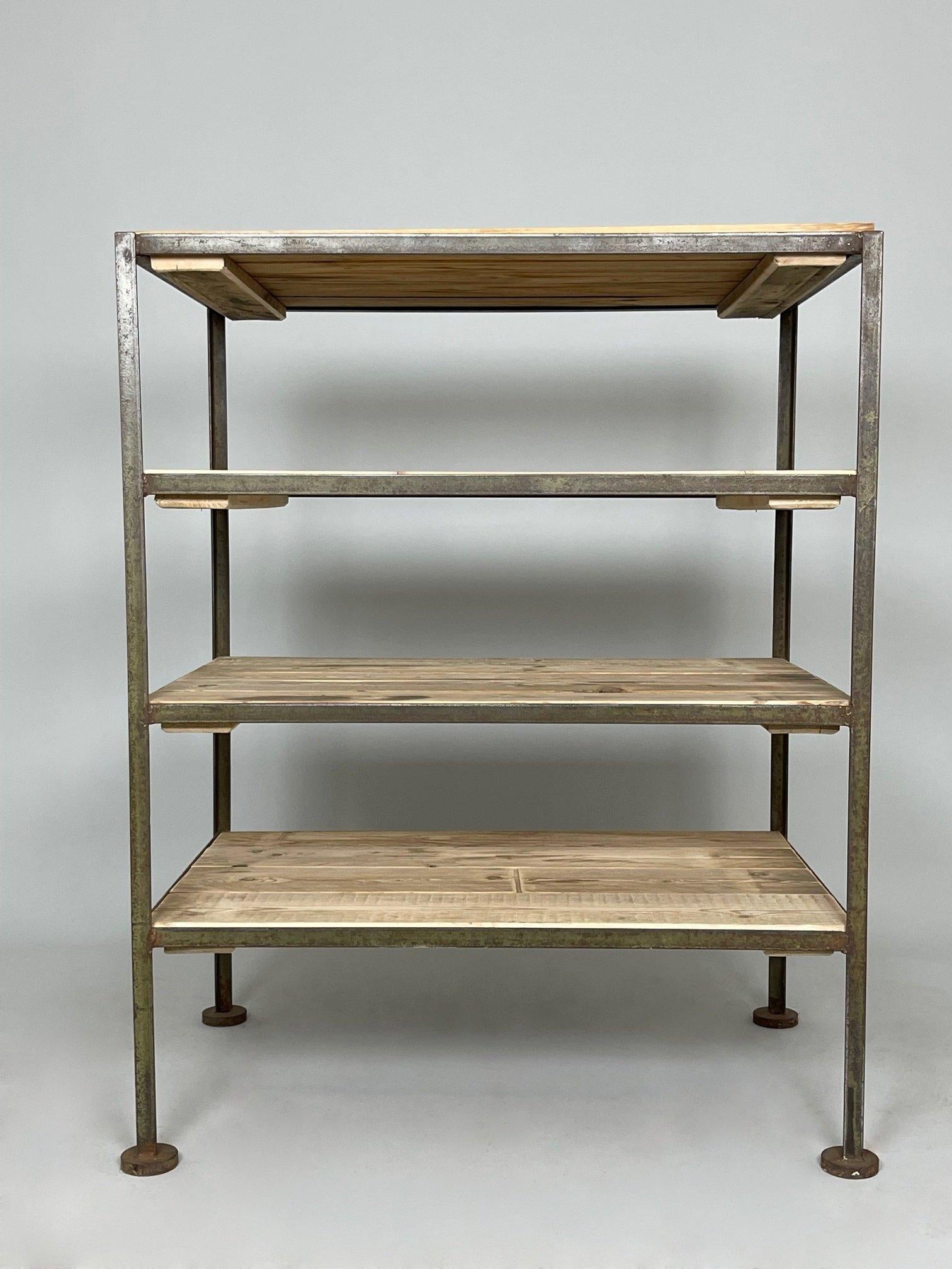 Vintage industrial shelf rack made of metal and wood. The original metal part was rescued from a factory in former Czechoslovakia and has been thoroughly cleaned. The wooden shelves are made of recycled wood.