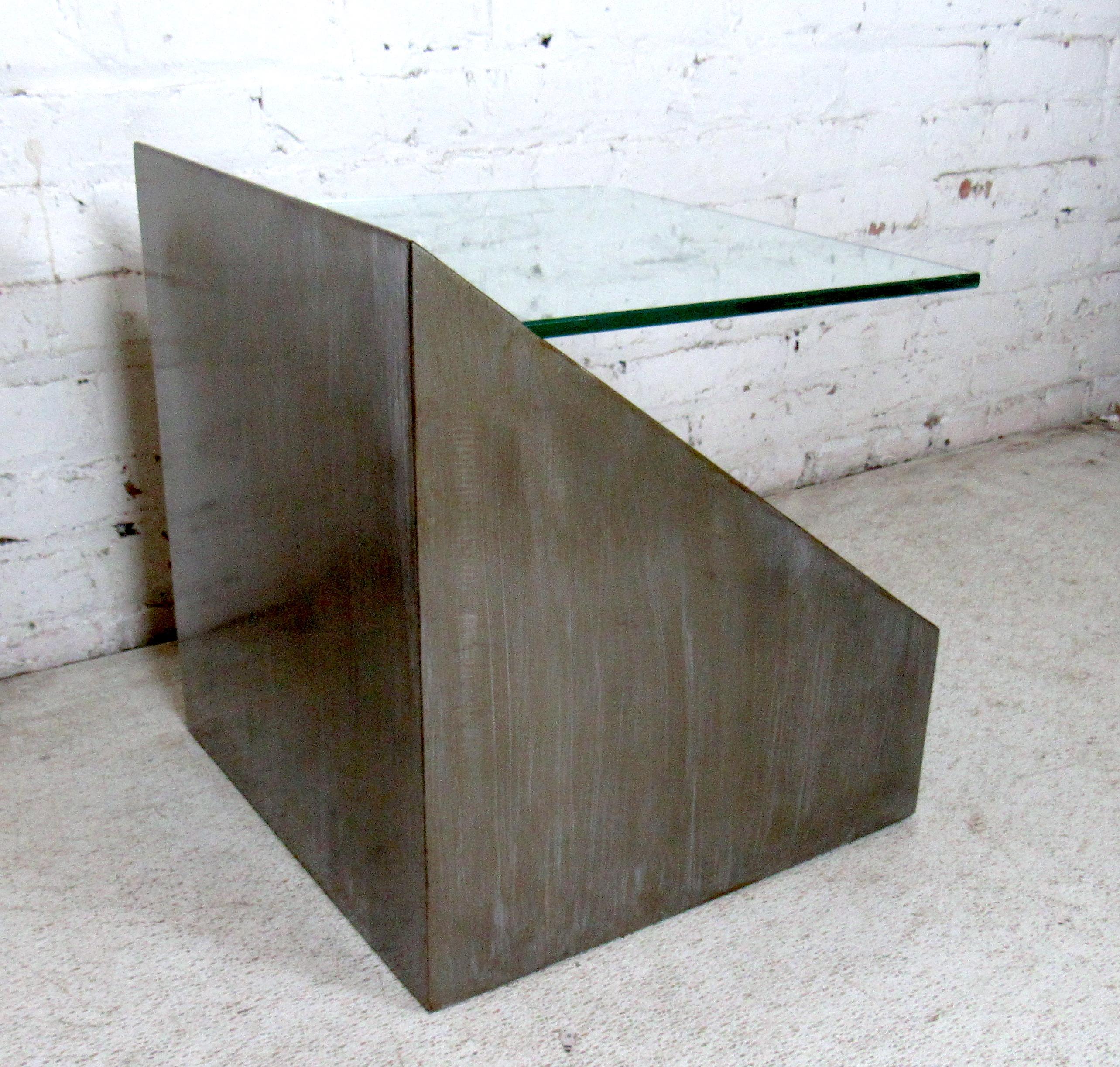 Industrial metal side table featuring a glass top that sits in the base.

Please confirm item location (NY or NJ).