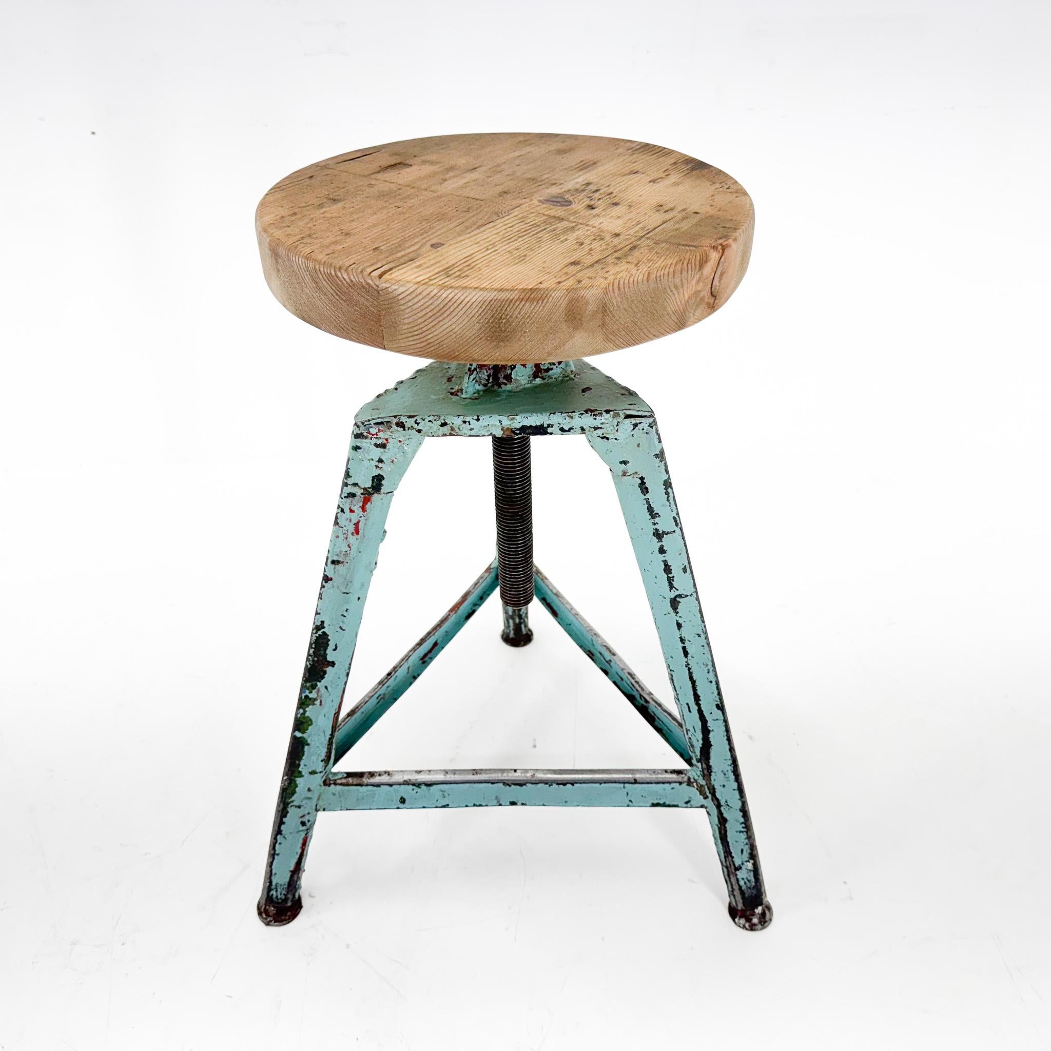 Vintage industrial tripod stool, made of steel and wood. Saved from a factory in former Czechoslovakia. The diameter of the seat is 32 cm. The widest point at the bottom of the legs is 46 cm. 