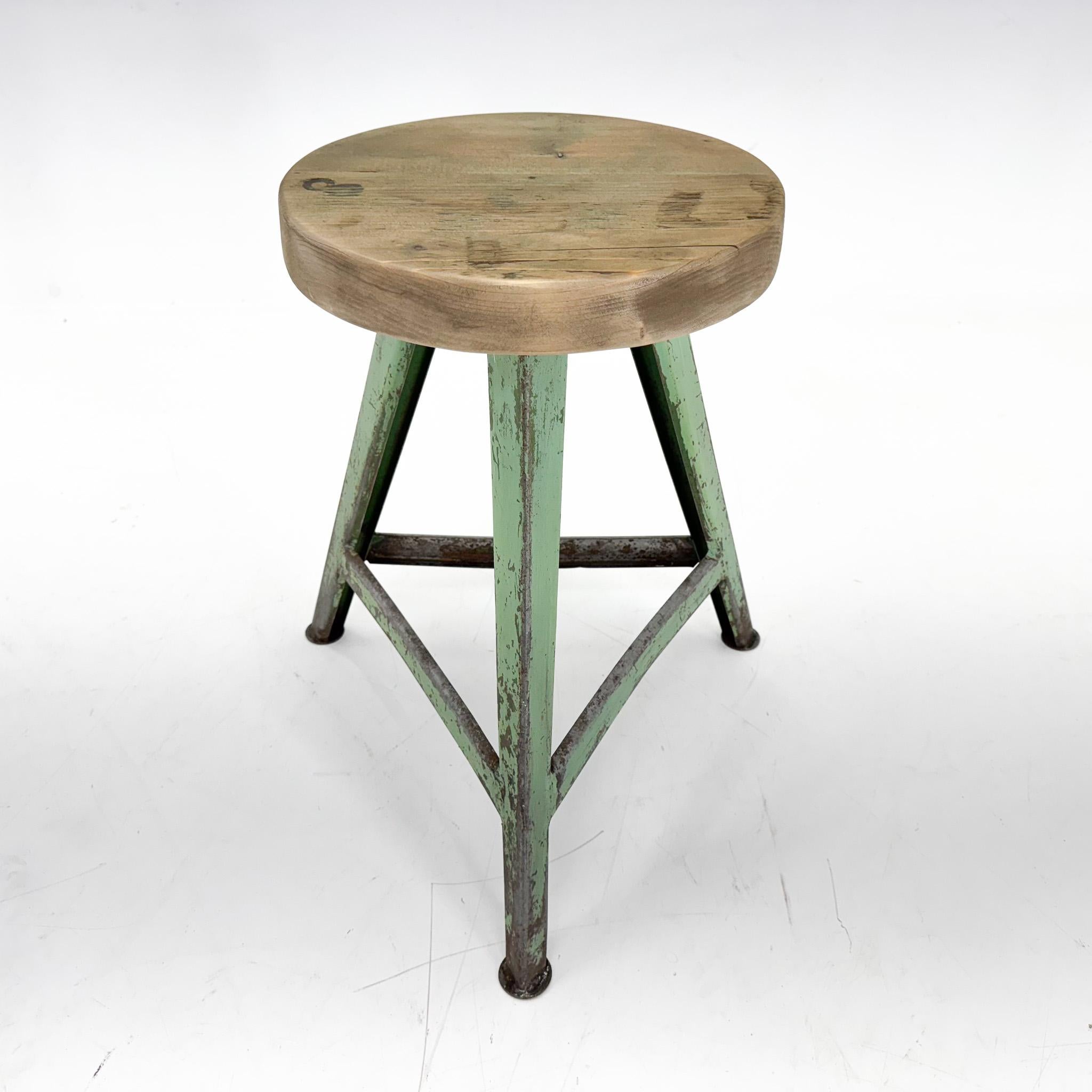 Vintage industrial tripod stool, made of steel and wood. Saved from a factory in former Czechoslovakia. The diameter of the seat is 32 cm. The widest point at the bottom of the legs is 47 cm. 