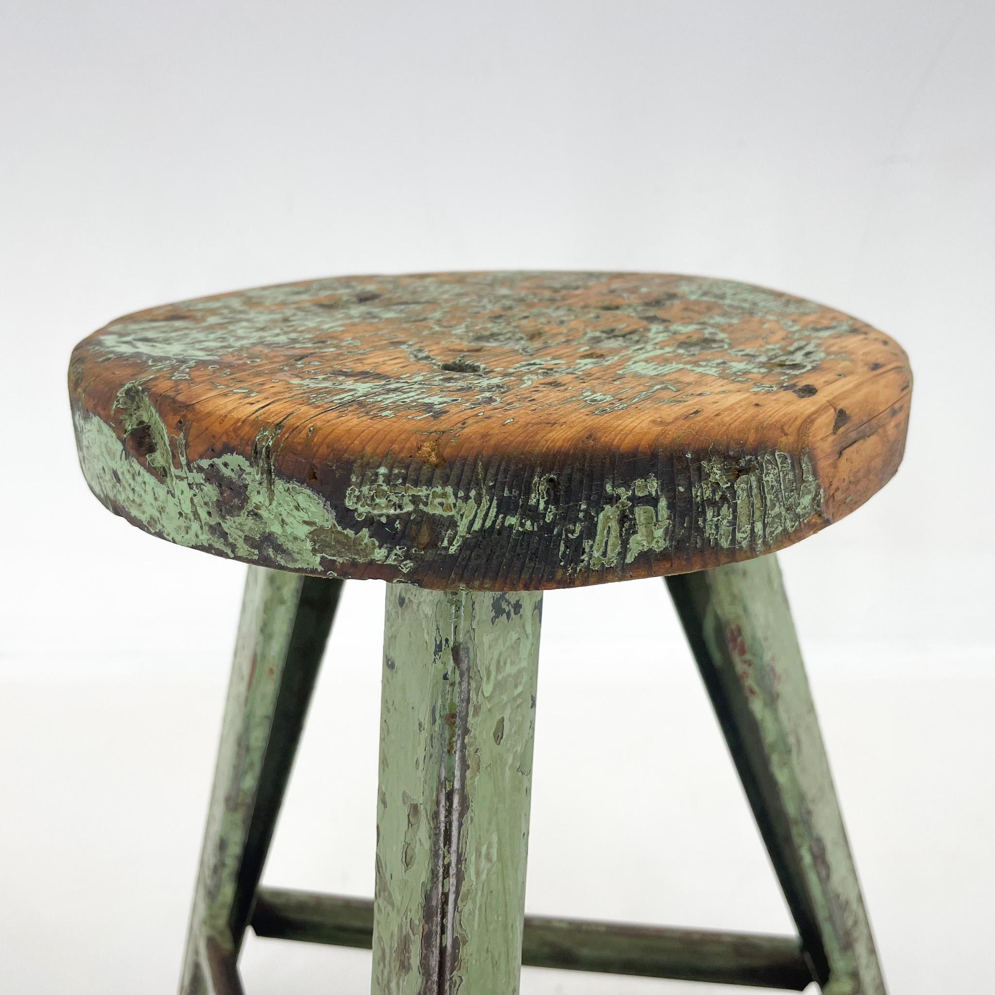 Vintage industrial tripod stool, made of steel and wood. Saved from a factory in former Czechoslovakia. The wooden seat was treated with a special oil. The diameter of the seat is 28 cm. The widest point at the bottom of the legs is 48 cm.