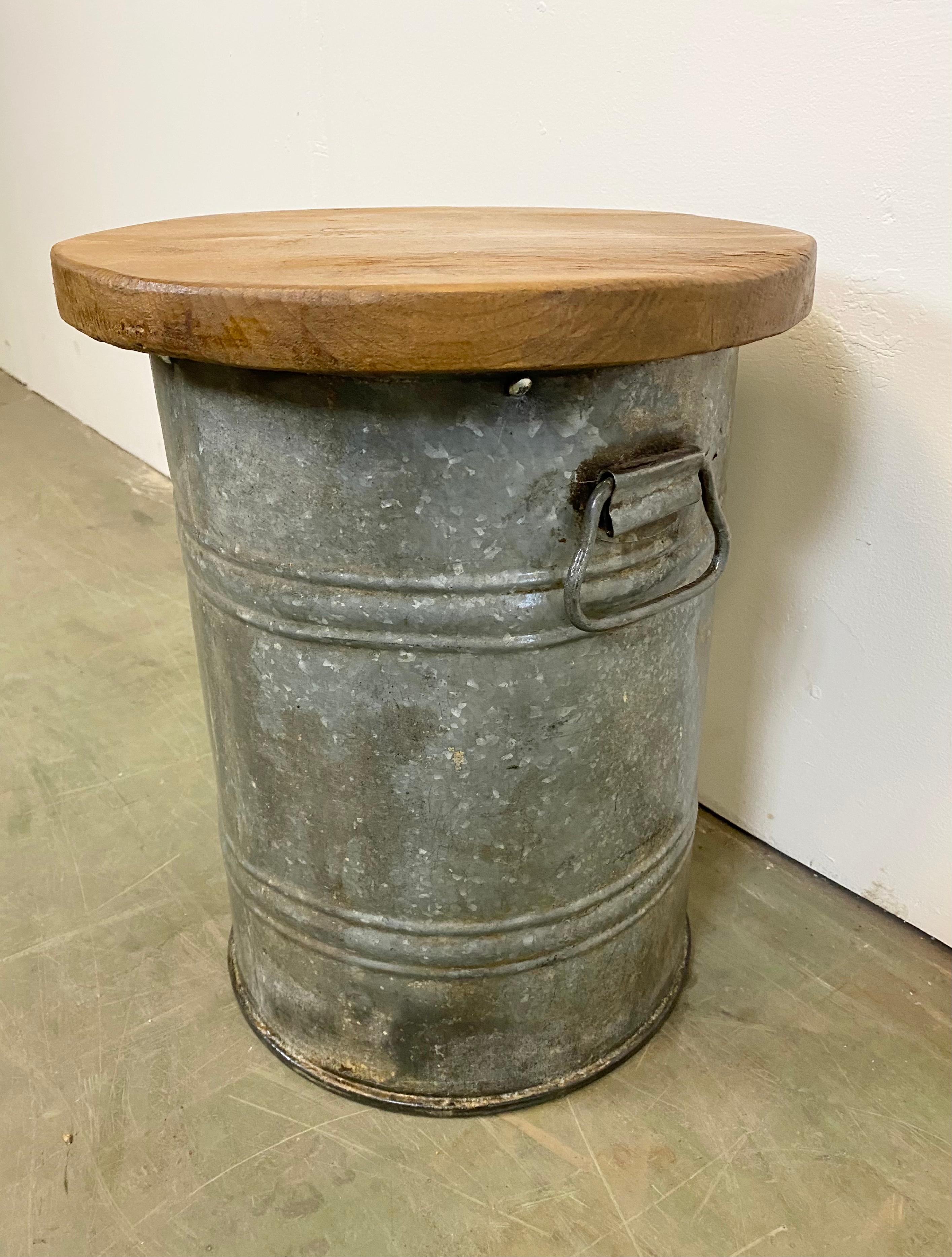Vintage Industrial stool. It features a grey iron body and a solid wooden seat. The weight of the stool is 7 kg.