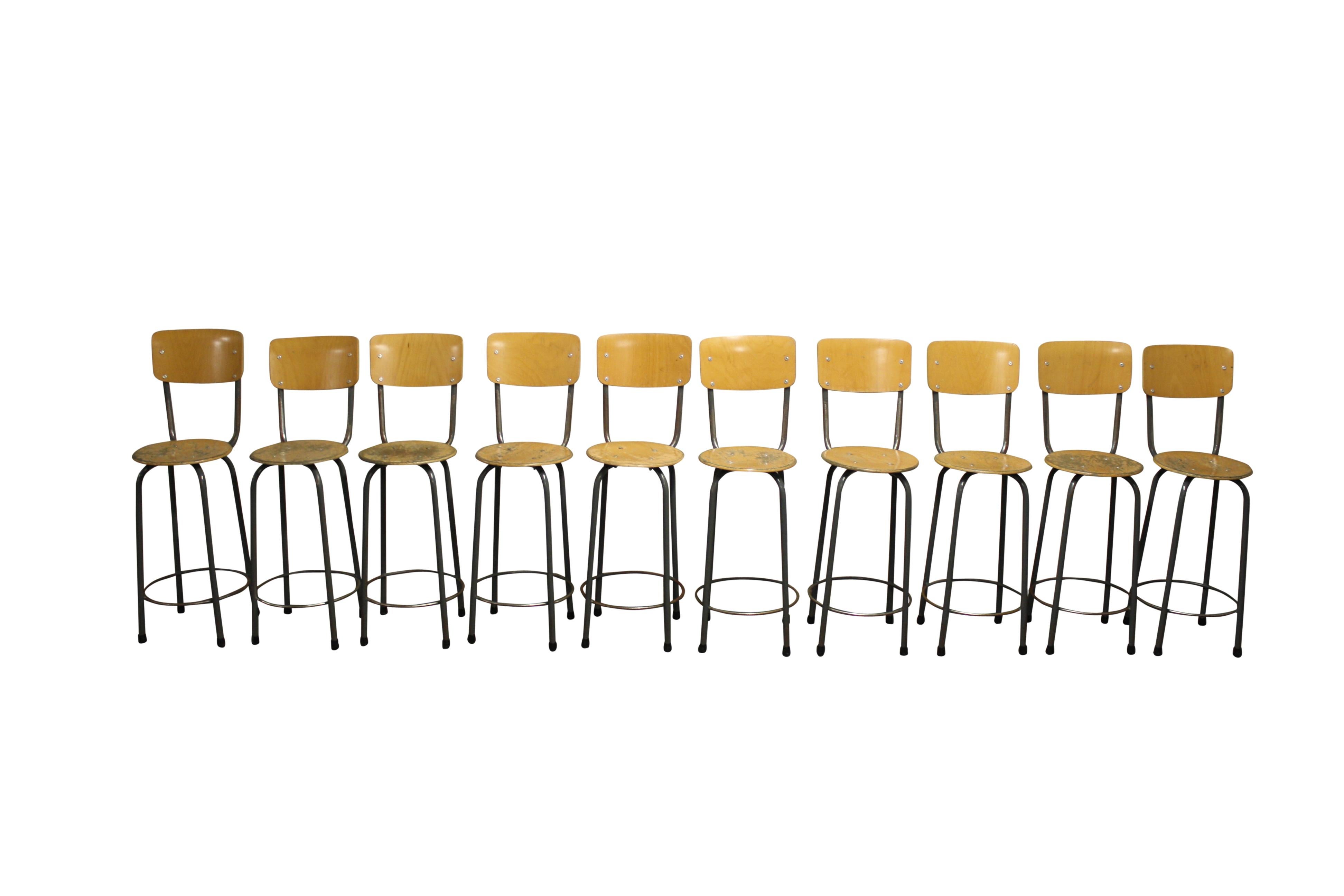 Salvaged industrial stools with a tubular steel frame and wooden seat and backrests.

The stools come from a school in wallonia (belgium) and were used as laboratory stools. 

The school opened in the late 1950s and these stools where used all
