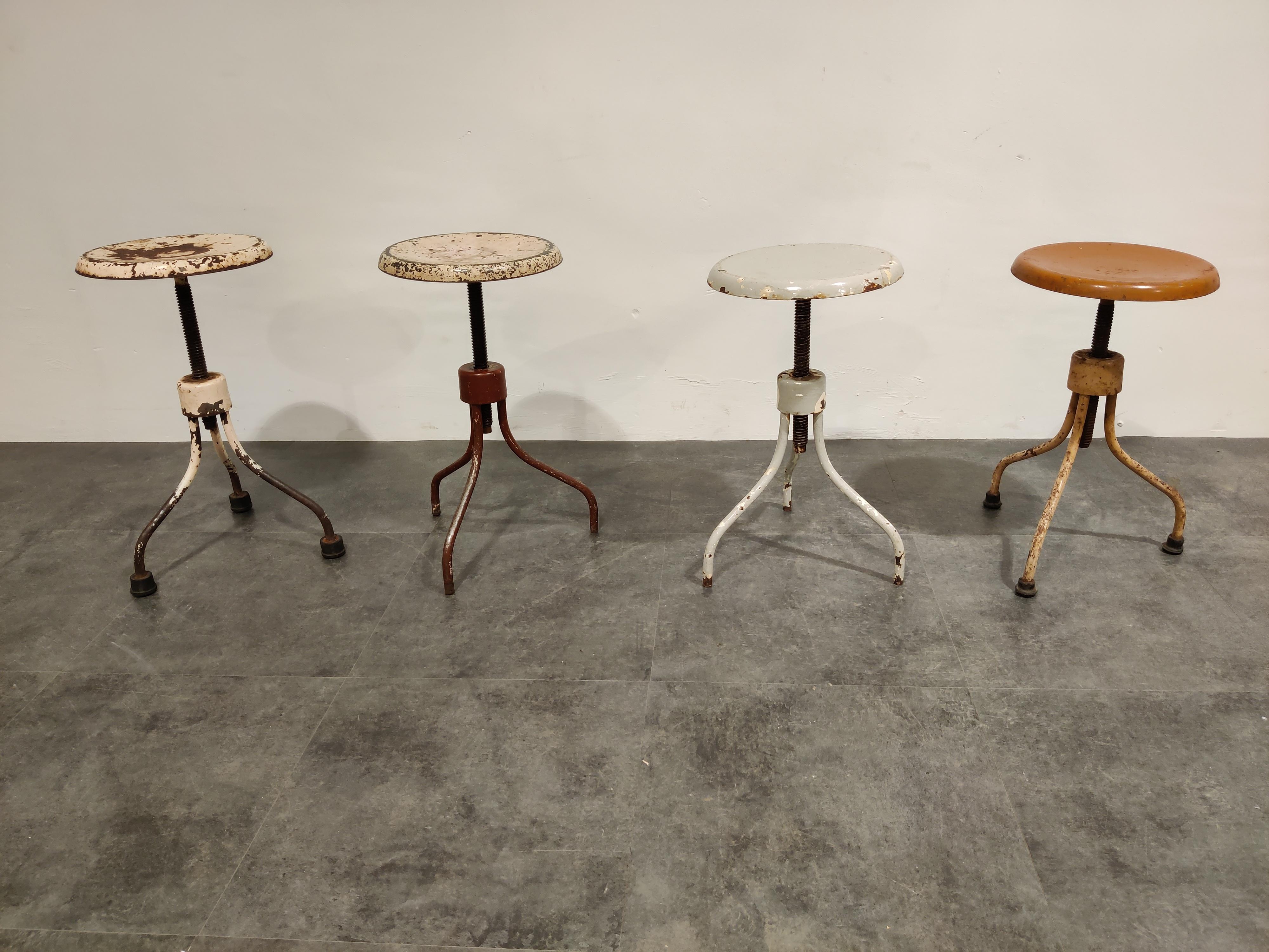 Nicely worn cast iron industrial stools.

The stools have turnable seat mounted on a cast iron base.

The simple design makes them attractive.

The height of the stools can be adjusted by turning the top, they can be set another 30cm in