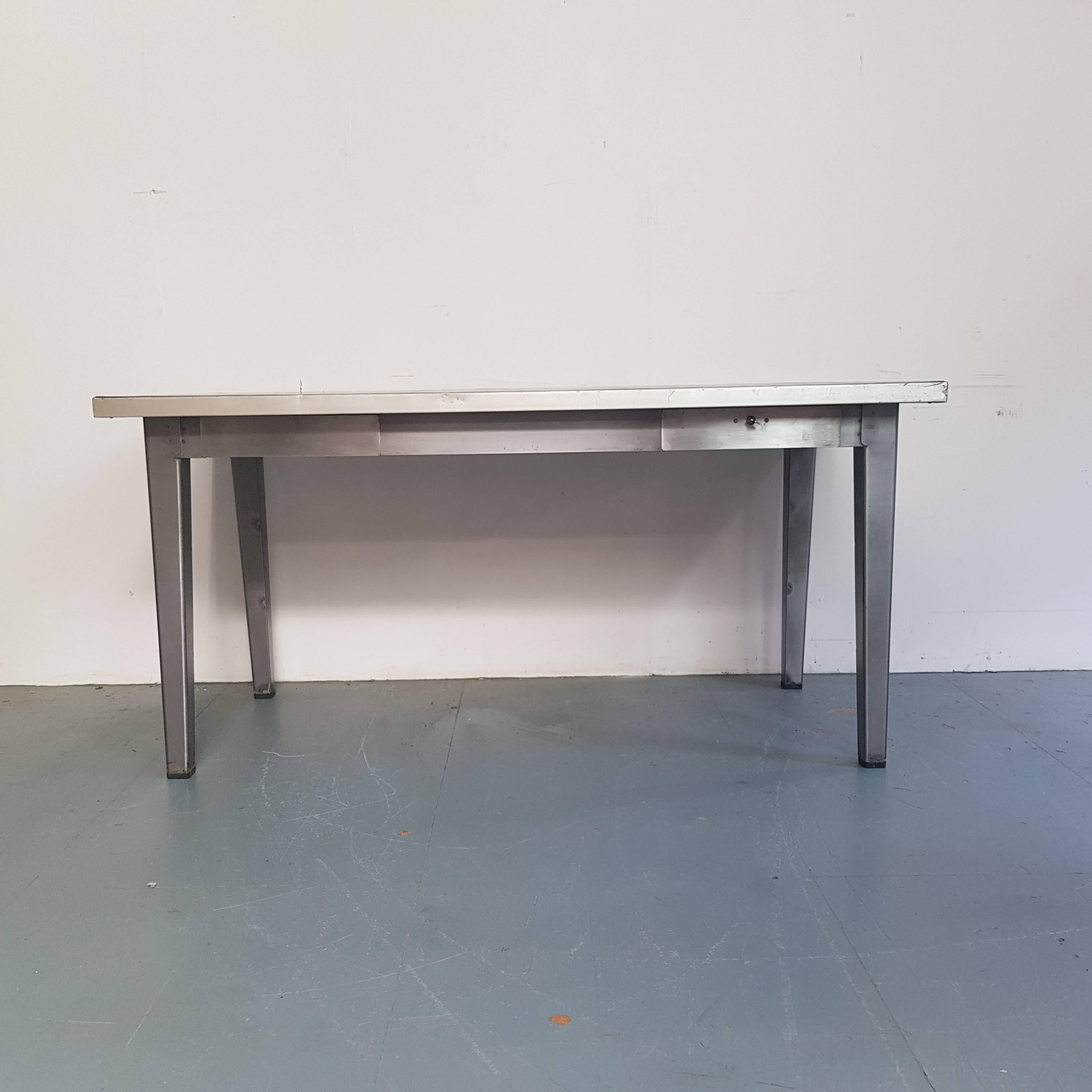 Lovely vintage industrial stripped and polished steel table with drawers with original rubber top.

Working lock and key on one drawer.

In good vintage condition - this piece comes from a working Industrial environment and so has signs of wear