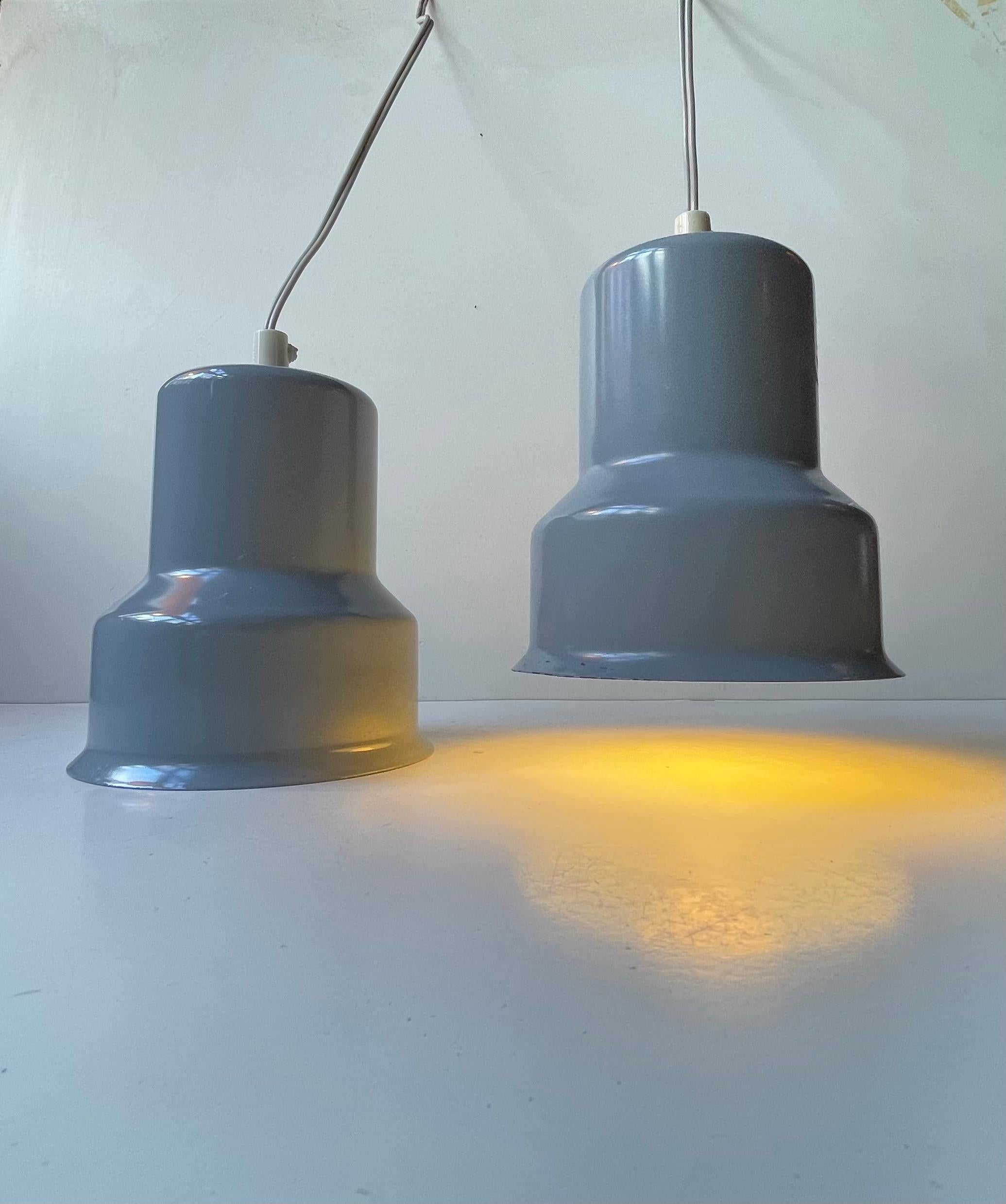 A pair of small elephant grey pendant lights in lacquered steel. Designed and manufactured by ABO in Denmark during the 1970s. Grey exterior with reflective white interior shading. Suitable as kitchen, workspace or corridor lighting etc. Reminiscent