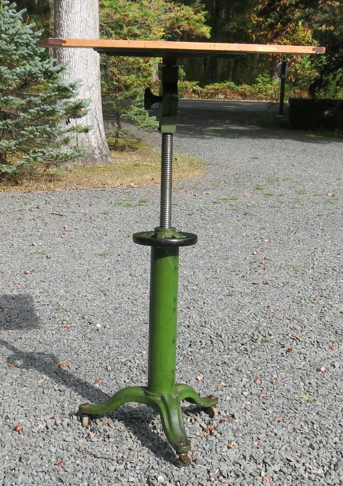 Vintage Industrial table with wood top. Beautil green color base that raises and tilts on wheels. Normal wear to paint, top has been lightly sanded and sealed. It can raise from 36.5