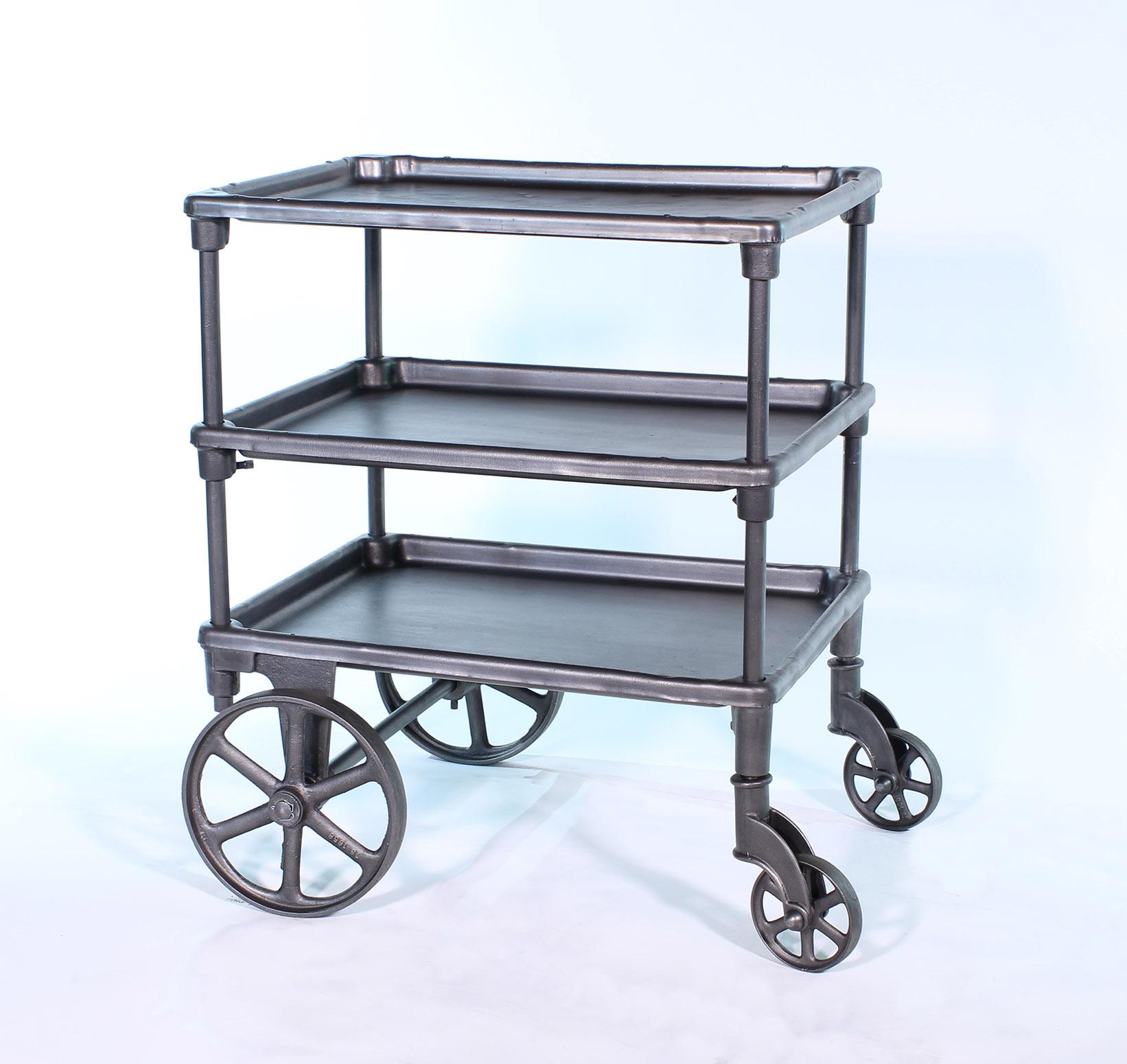 Authentic early 1900s cast iron and steel adjustable three-tier rolling bar cart on castors. Middle shelf is adjustable in height. Top measures 26 1/4