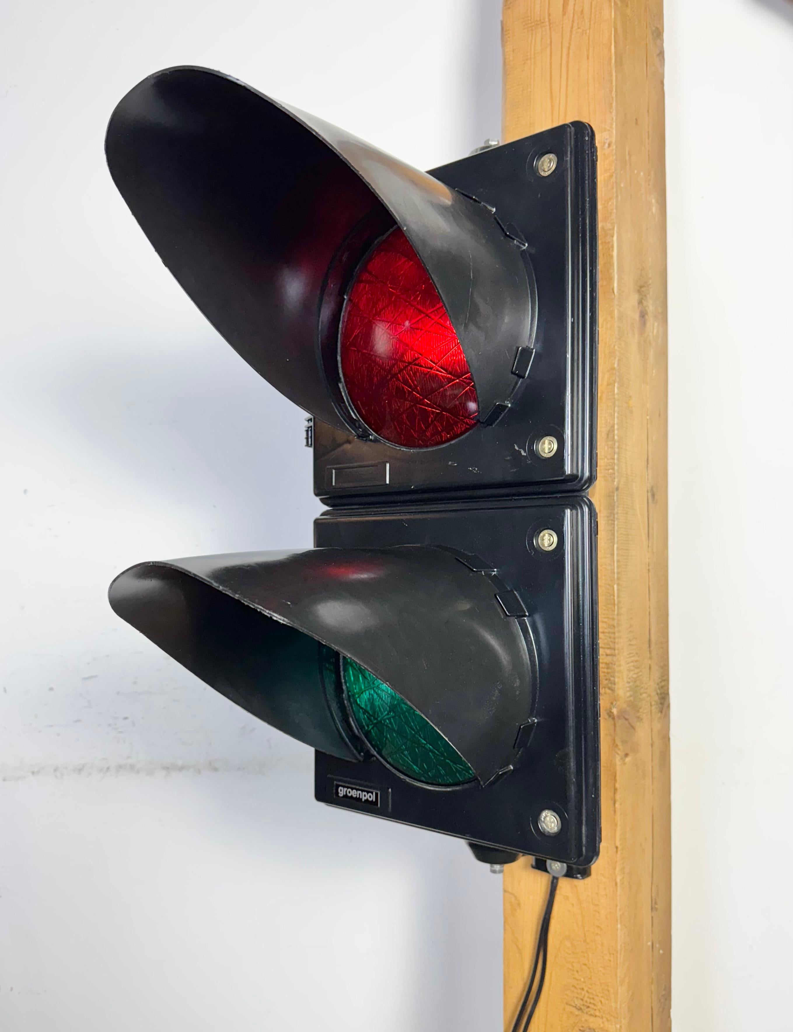Vintage industrial traffic lights made by Groepol in Netherlands in the 80s-90s. Was used during road works to temporarily replace local traffic lights.It features black bakelite body and color plastic glass covers. The sockets require standard E