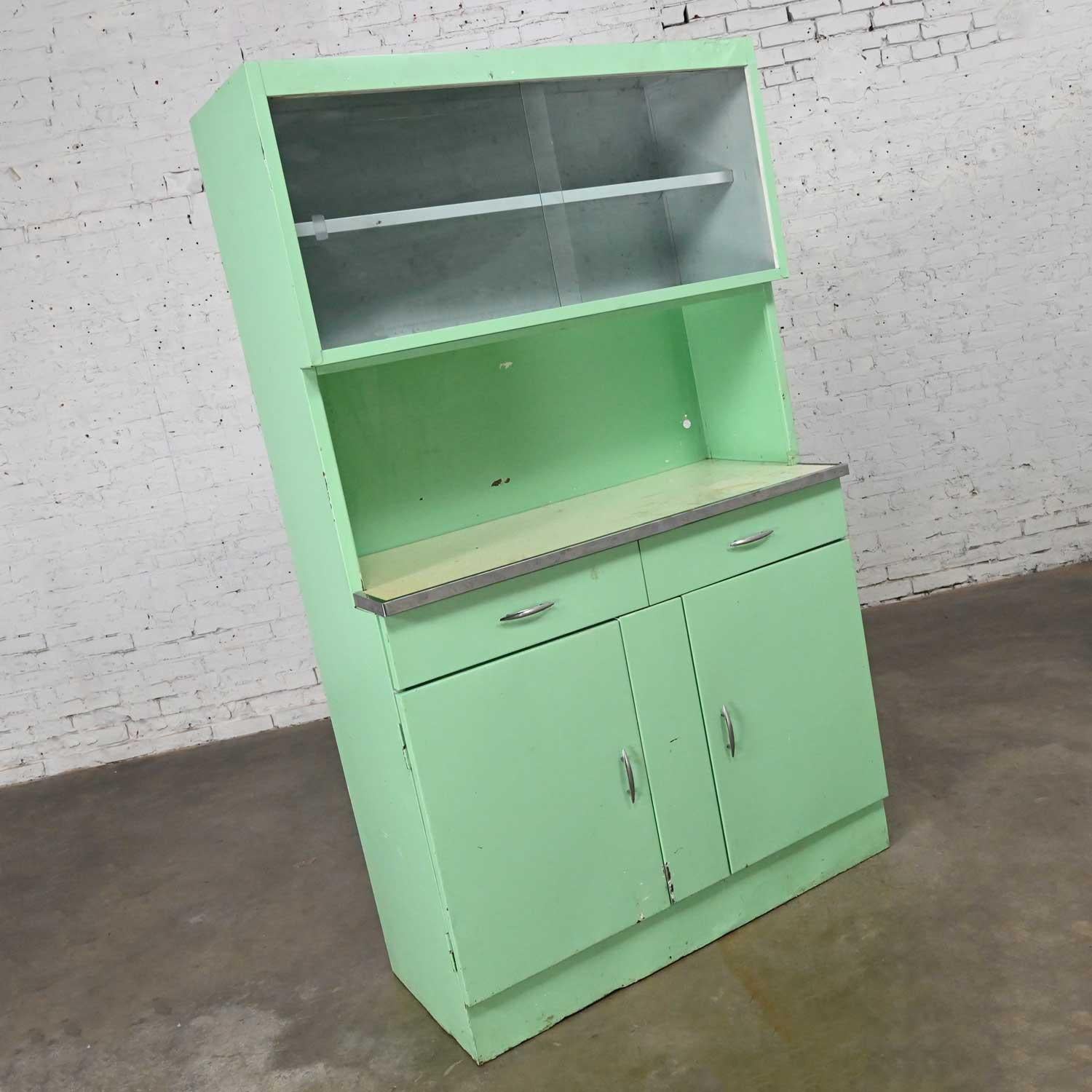 Handsome vintage Industrial turquoise metal cupboard or cabinet with upper sliding glass doors and chrome hardware. Beautiful condition, keeping in mind that this is vintage and not new so will have signs of use and wear. There is an all-over