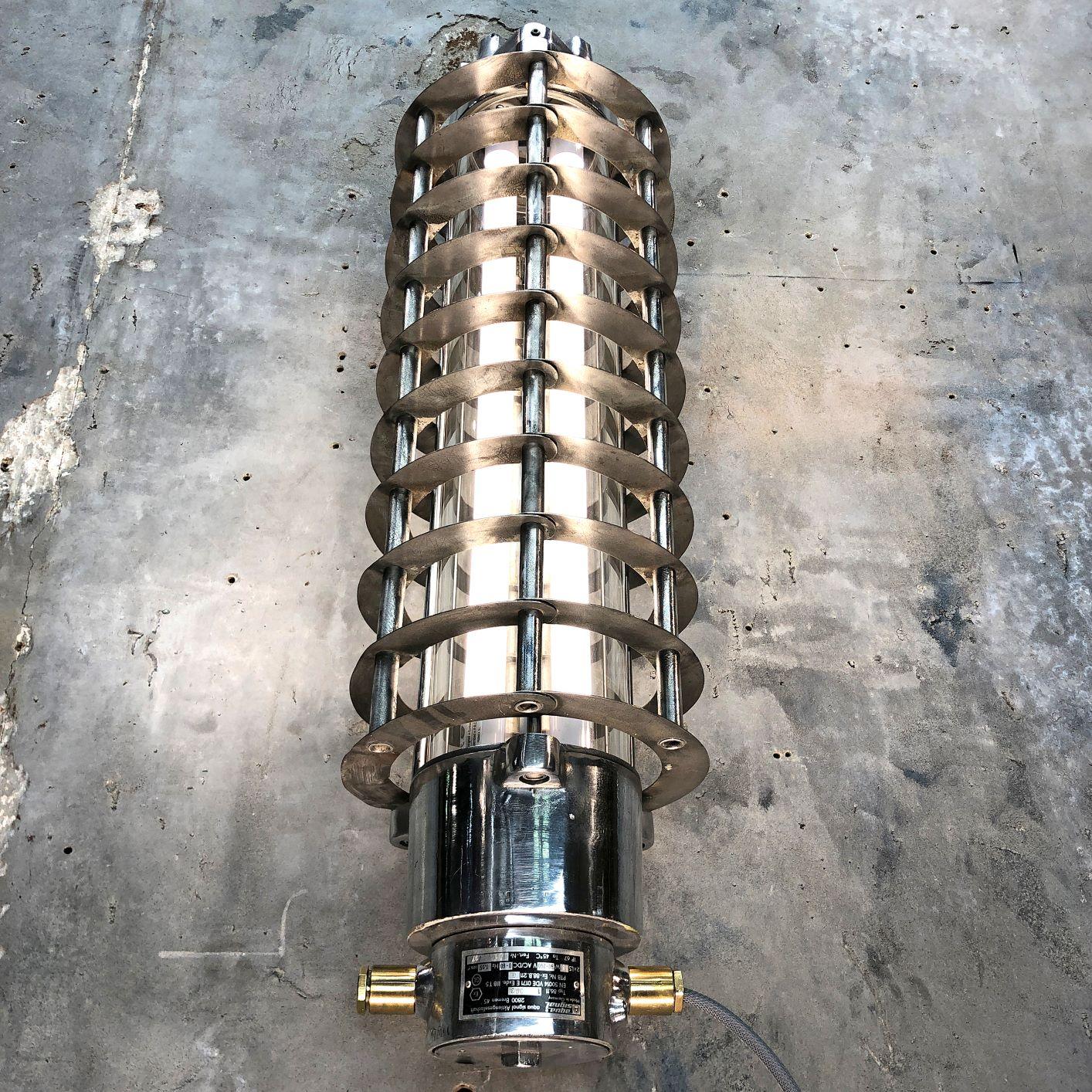 A retro Industrial aluminum wall-mounted flameproof striplight with protective cage by Wittenberg. Reclaimed from supertankers and military vessels then professionally stripped, restored and rewired by Loomlight in the UK.

This fixture is