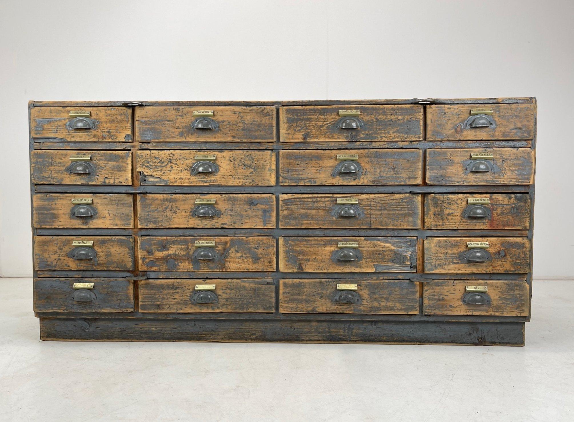 Amazing industrial wooden cabinet with 20 drawers marked with original metal labels. It was rescued from an old, screw factory in former Czechoslovakia.
Original patina, completely cleaned, sanded and waxed. It will elevate any interior and make it