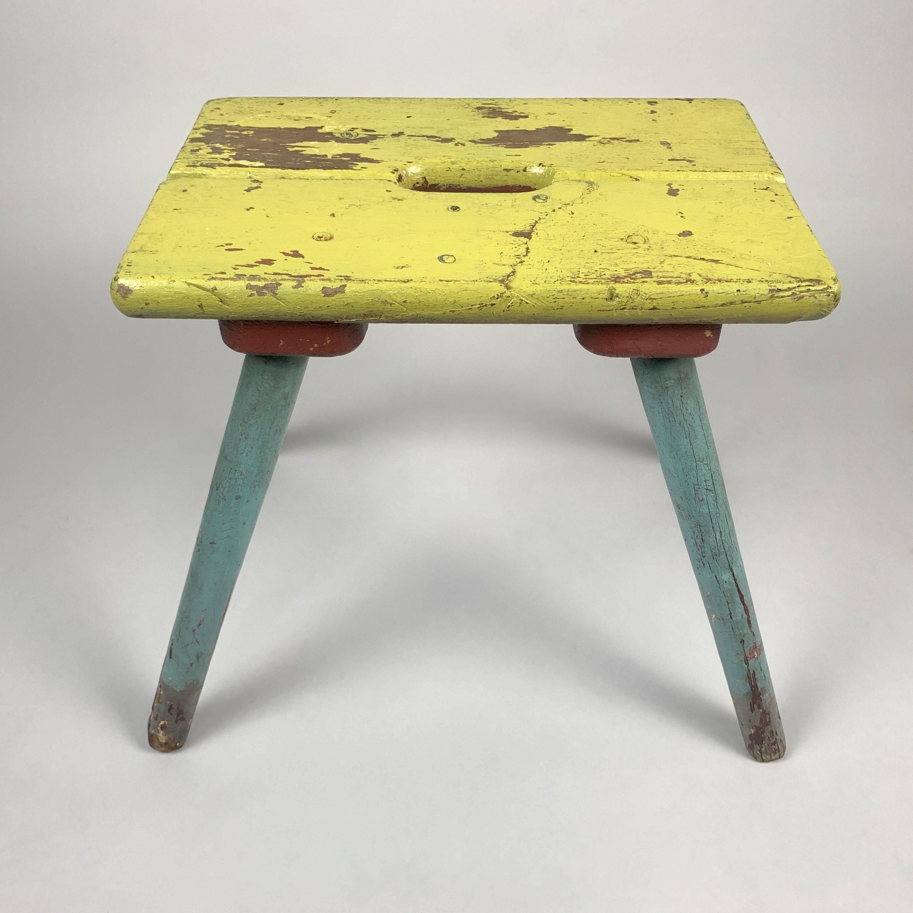 This unique vintage colorful wooden stool with original paint and naturally aged patina has a lot of character. The original chippy paint has been sealed. Even though it's legs look pretty worn out, it's still stable and ready to brighten up your