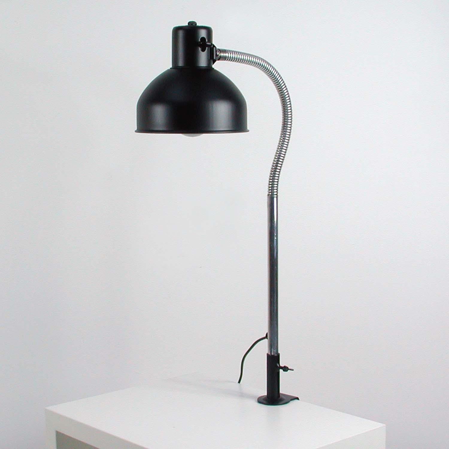 This 1950s Industrial work lamp was manufactured by Albert & Brause, in Neheim-Huesten in the 1950s. It is made of black lacquered steel and has got an adjustable chrome gooseneck lamp arm and adjustable shade. The switch is made of Bakelite.