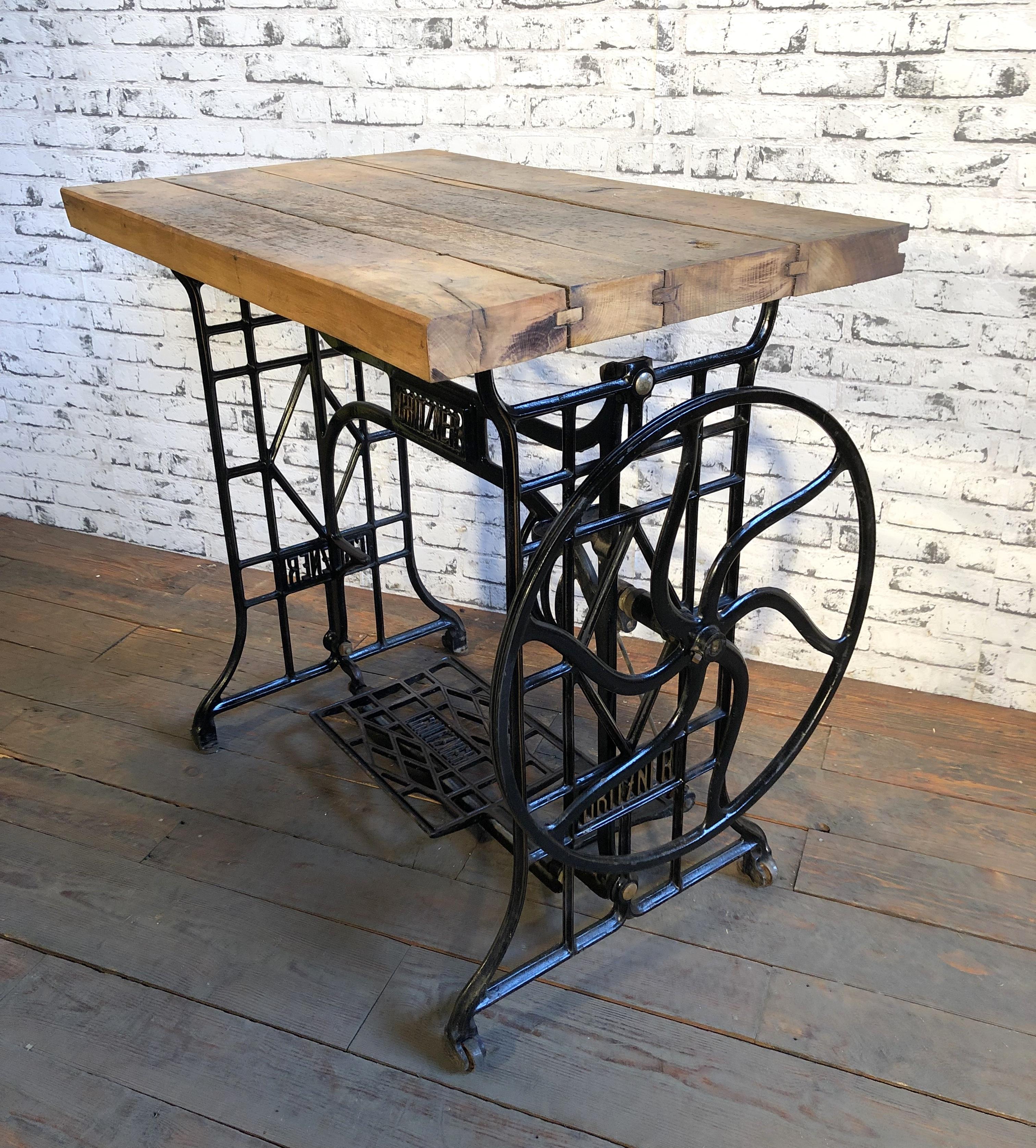 This industrial table comes from the 1930s. Old wooden top was recently mounted on a sewing machine cast iron base. Weight of the table is 39 kg.