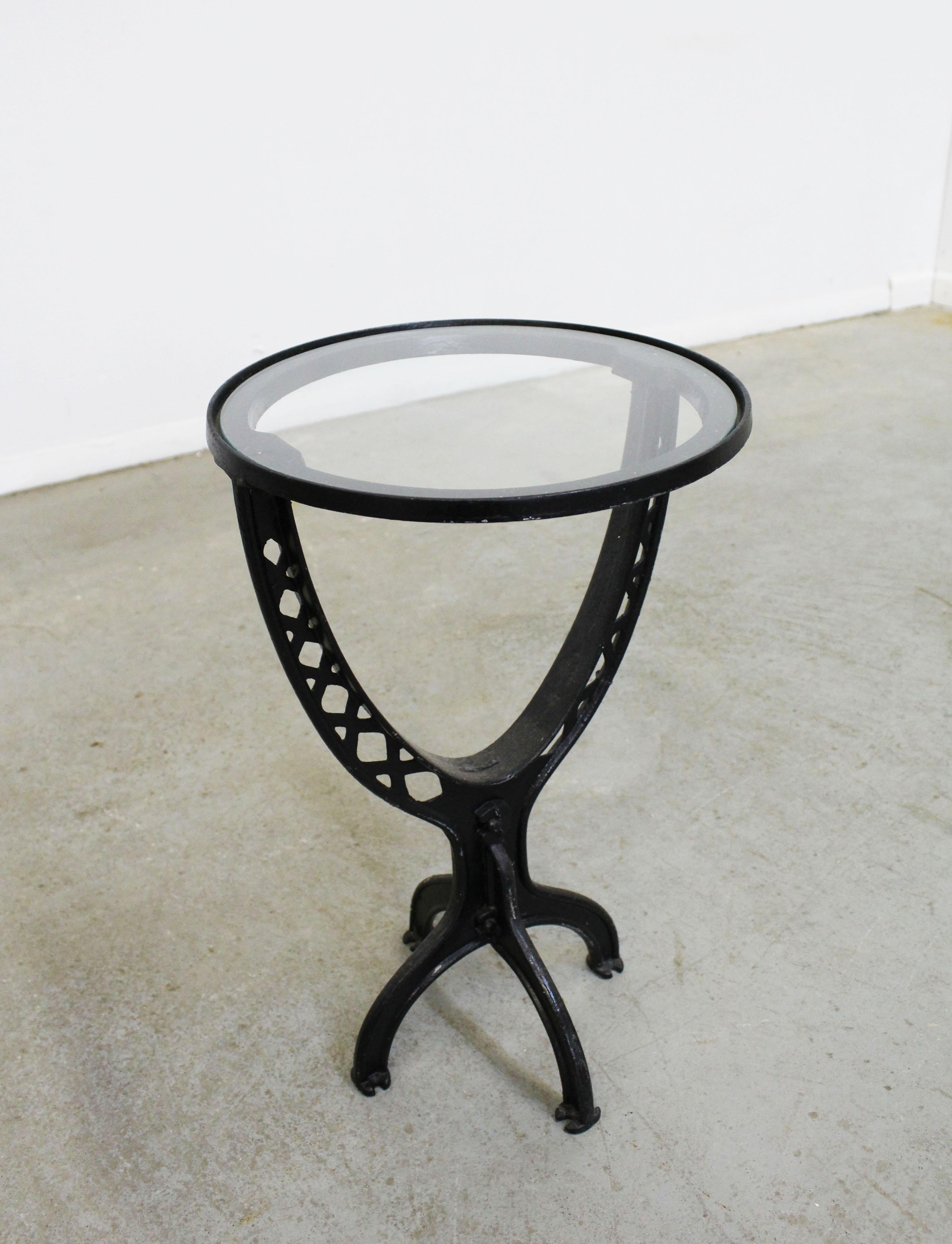 Offered is a wrought iron table made from salvaged architectural Industrial parts with added glass tops. This piece is super unique, custom made piece converted into an end table. We are unsure of the exact age. It's in good condition showing normal