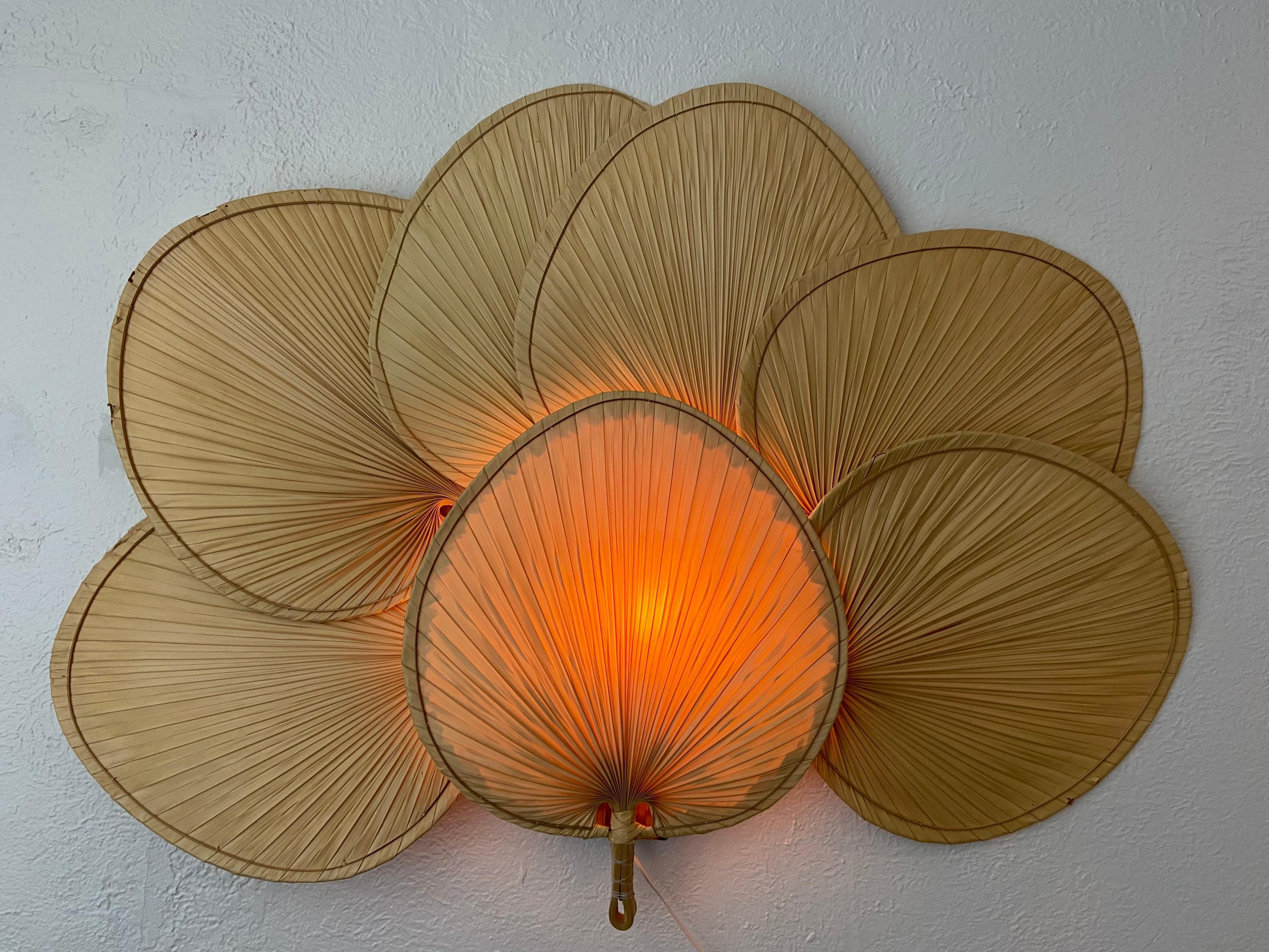 Vintage Ingo Maurer Uchiwa style wall lamp. Extremely rare example. Outer edges are tattered on some fans (please refer to photos). Original as found wiring and socket. In working order. Overall great vintage condition. 

Would work well in a